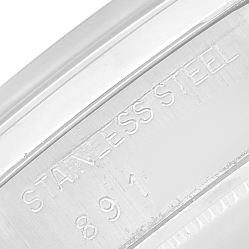 The image shows a close-up angle of the engraved stainless steel case back of a Vintage Collection model by Rolex.