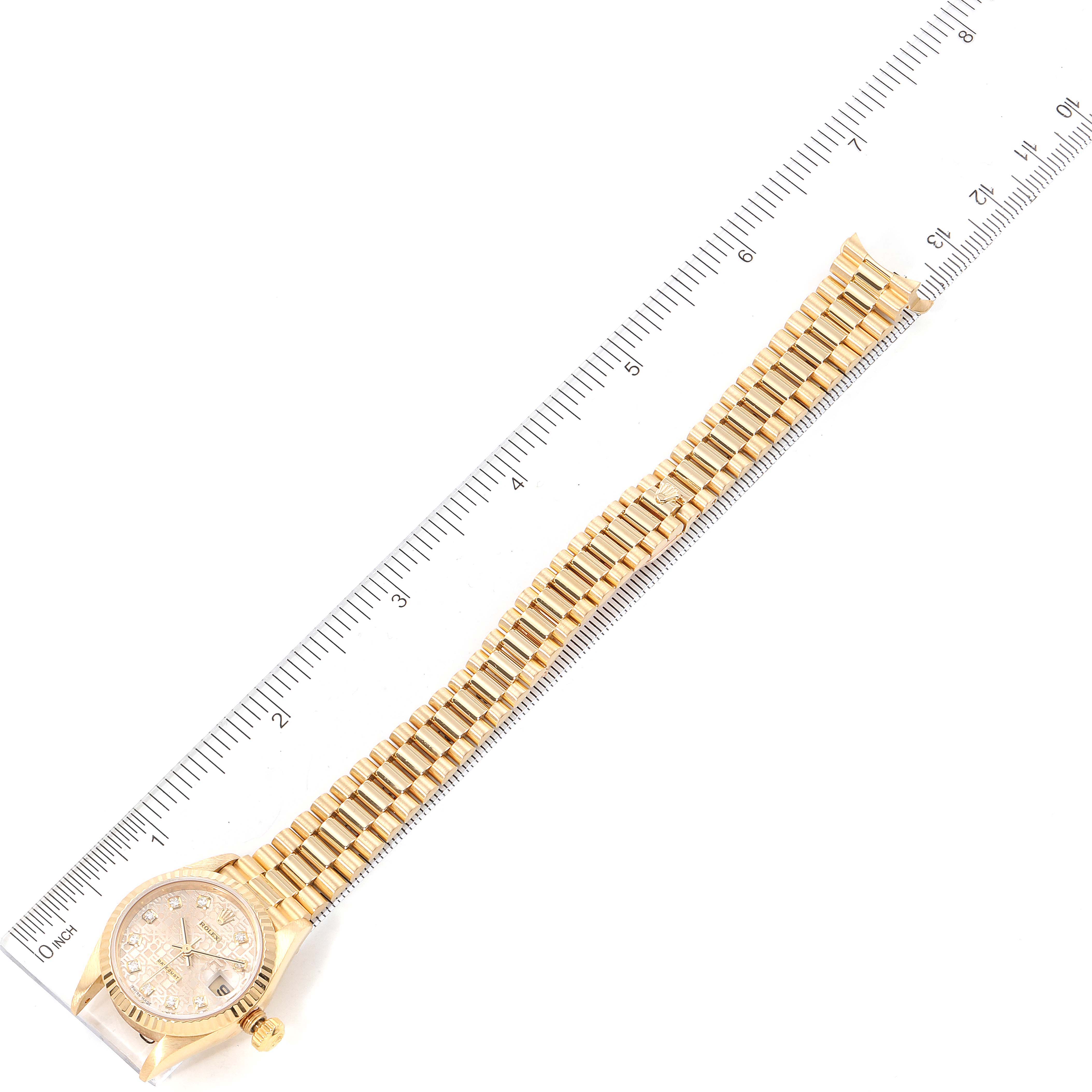 The image shows a top-down view of a Rolex President 79178 Women
s Yellow Gold Champagne Dial 79178 Women
s Yellow Gold Champagne Dial watch, including the dial, case, and entire bracelet with a ruler for scale.