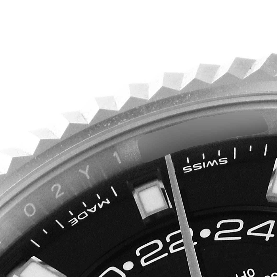This image shows a close-up of the bezel, part of the dial, and hour marker of the Rolex Sky-Dweller 326934 Men's Stainless Steel Black Dial 326934 Men's Stainless Steel Black Dial watch.