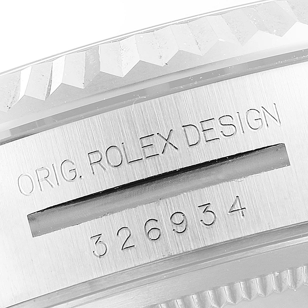 This is an angled close-up of the Rolex Sky-Dweller 326934 Men's Stainless Steel Black Dial 326934 Men's Stainless Steel Black Dial's case edge, showcasing the model number and the "Orig. Rolex Design" engraving.