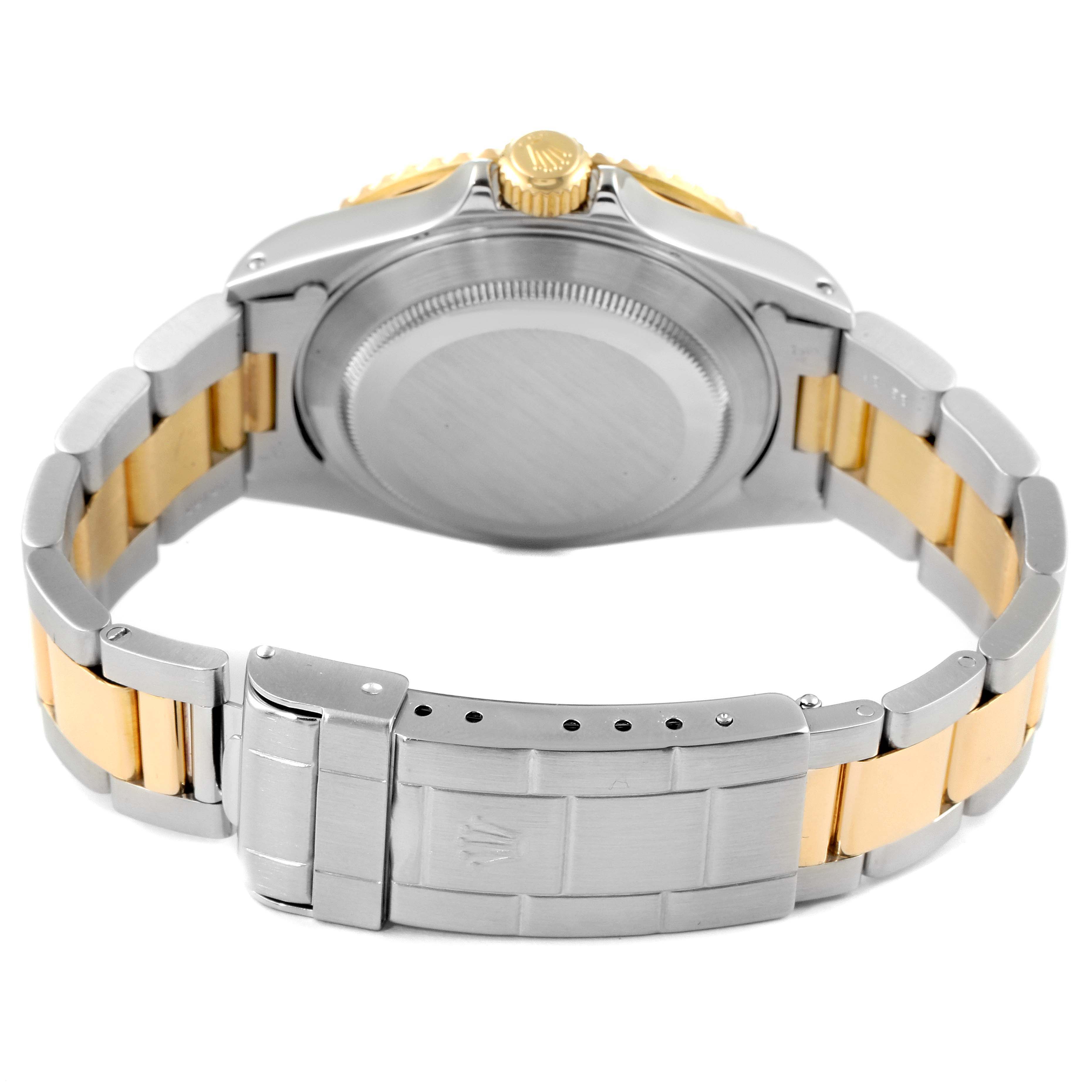 The image displays the back of a Rolex Submariner 16613 Men's Steel and Gold (two tone) Black Dial 16613 Men's Steel and Gold (two tone) Black Dial watch, highlighting its stainless steel and gold bracelet and clasp.