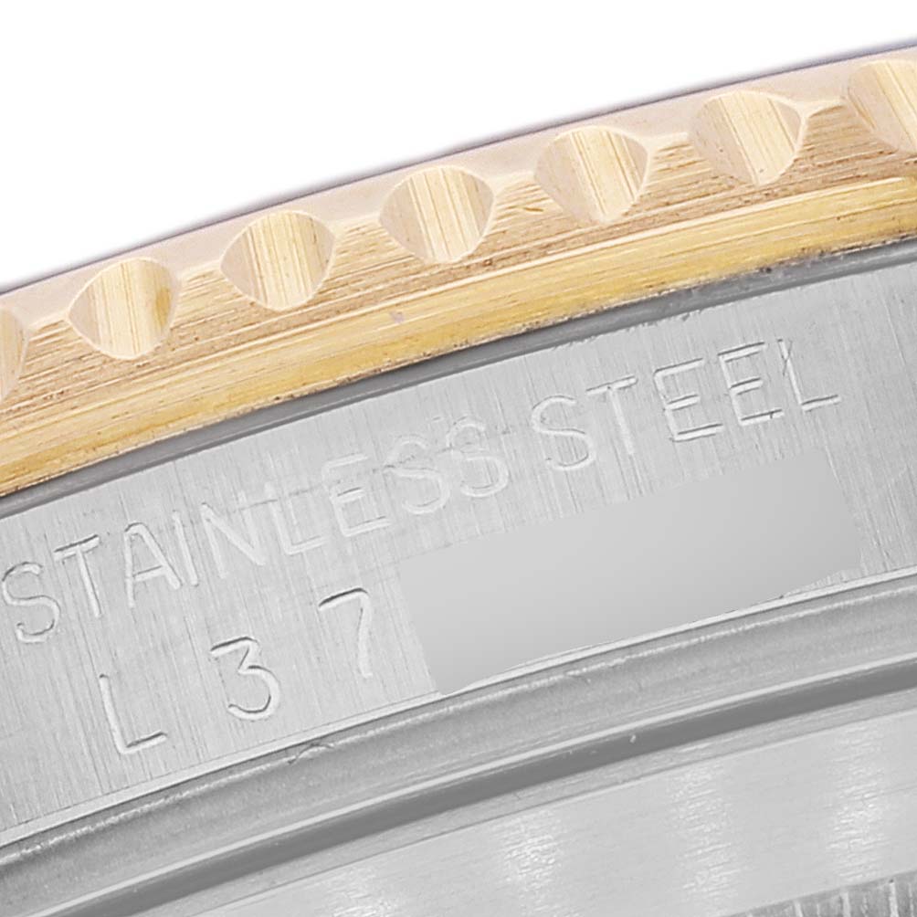 The close-up image shows part of the case back and bezel of a Rolex Submariner 16613 Men's Steel and Gold (two tone) Blue Dial 16613 Men's Steel and Gold (two tone) Blue Dial watch, highlighting the "STAINLESS STEEL" engraving.