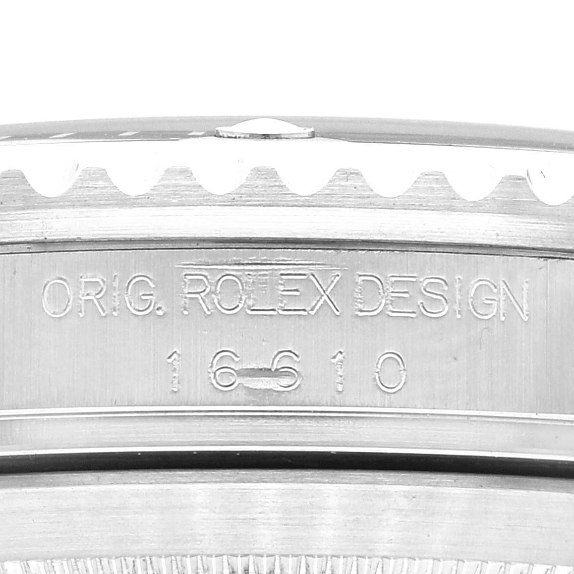 The image shows a close-up of the engraved side of a Rolex Submariner 16610 Men
s Stainless Steel Black Dial 16610 Men
s Stainless Steel Black Dial watch, displaying its design and model number (16610).