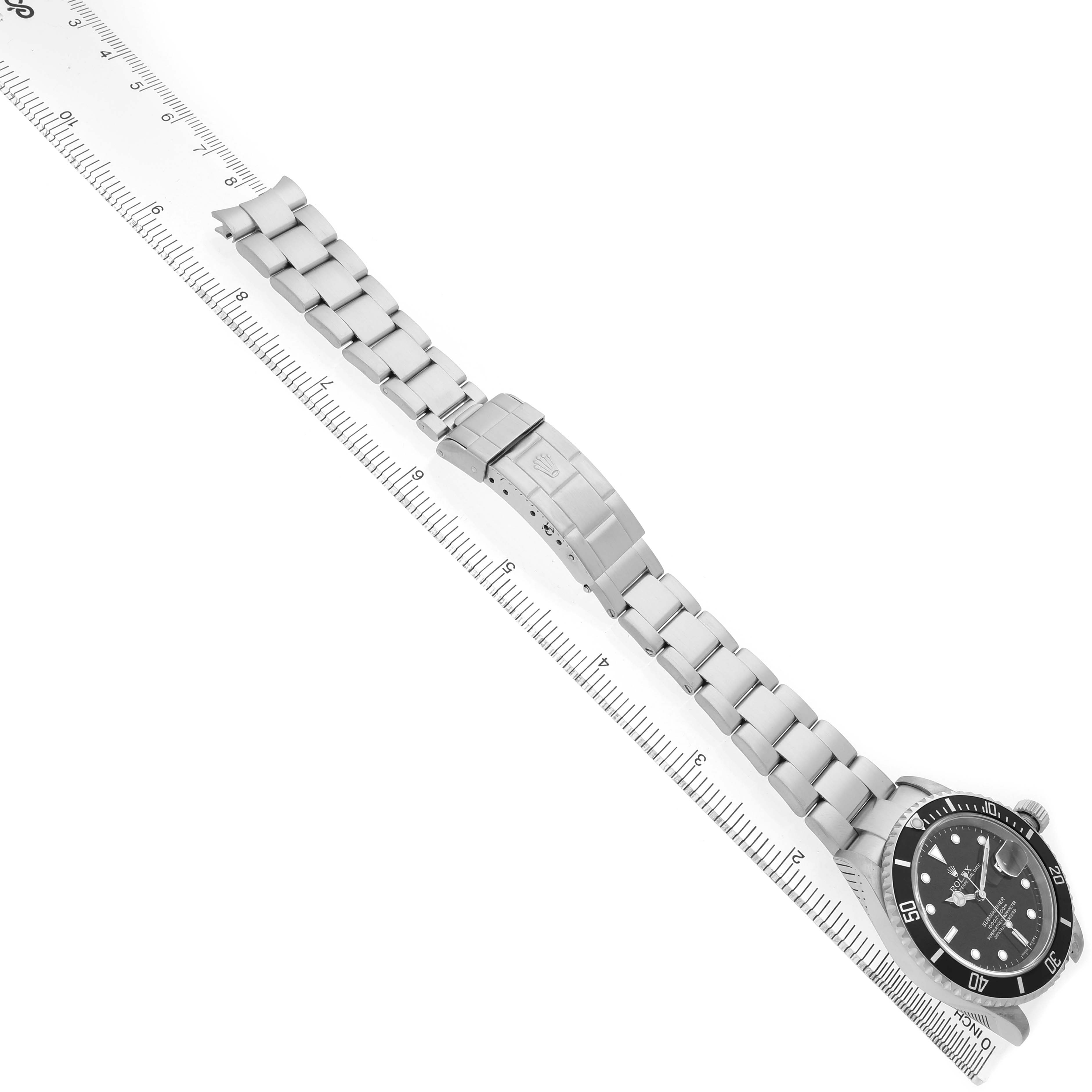 The Rolex Submariner 16610 Men's Stainless Steel Black Dial watch is displayed from an angled side view, showing its full bracelet, clasp, and dial.