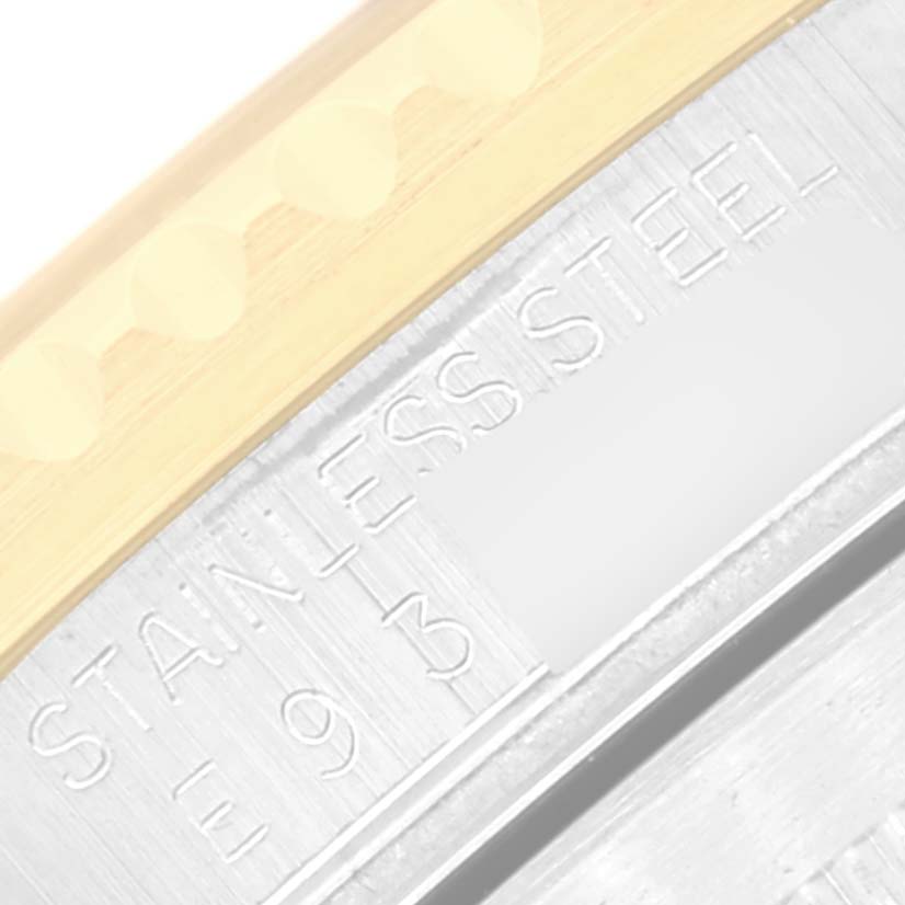 This close-up image shows the case back and part of the bezel of a Rolex Submariner 16613 Men's Steel and Gold (two tone) Black Dial 16613 Men's Steel and Gold (two tone) Black Dial, highlighting the "Stainless Steel" engraving.