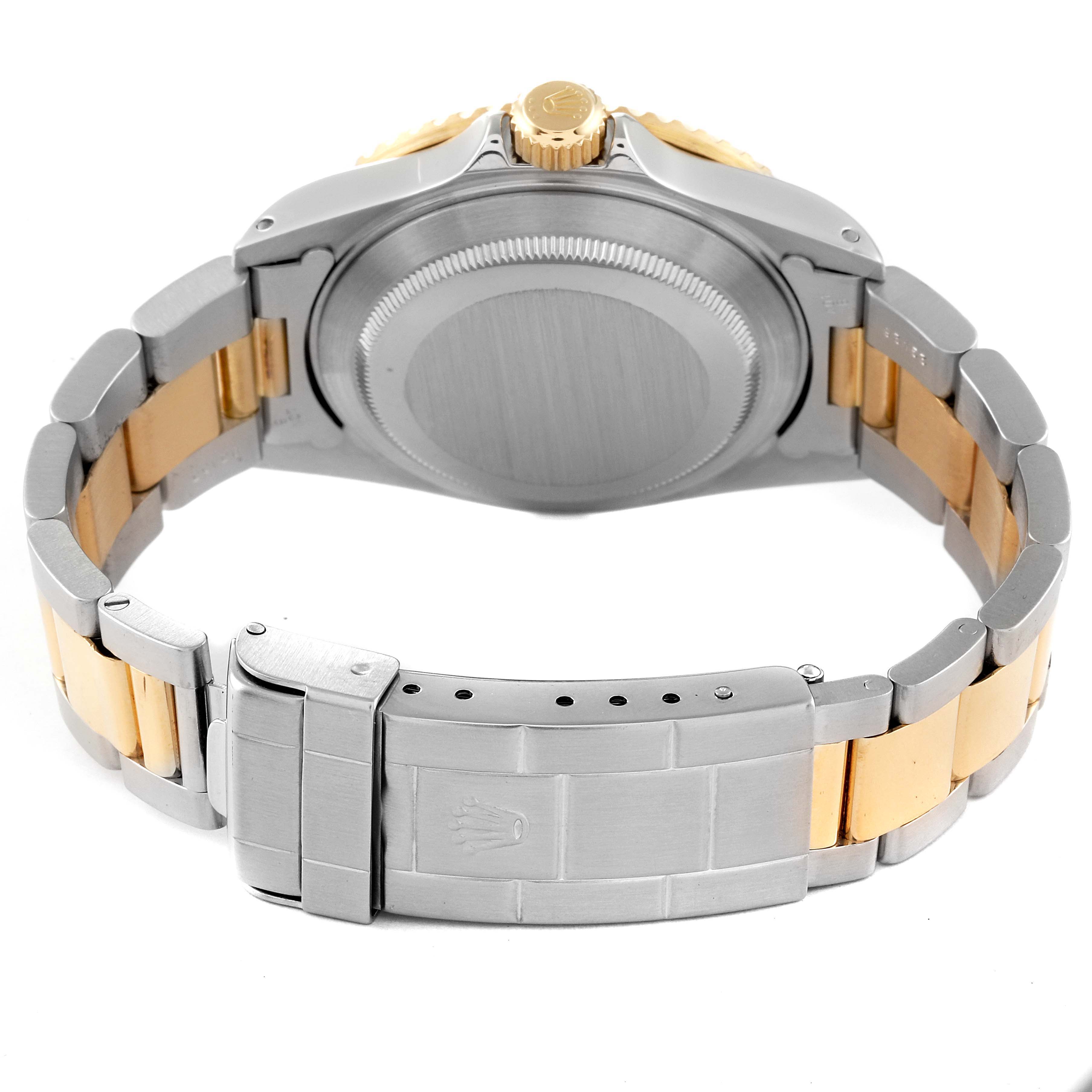 The image shows the back of a Rolex Submariner 16613 Men's Steel and Gold (two tone) Champagne Dial 16613 Men's Steel and Gold (two tone) Champagne Dial watch, highlighting its case back, crown, and metal bracelet.