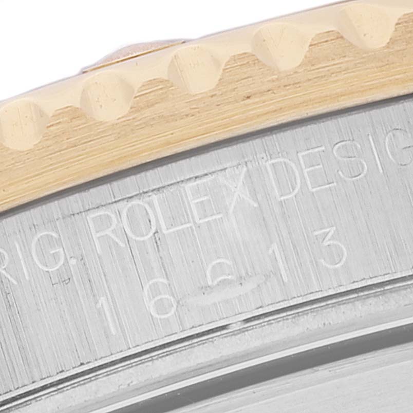 This close-up image shows the side of the bezel and caseback of a Rolex Submariner 16613 Men's Steel and Gold (two tone) Champagne Dial 16613 Men's Steel and Gold (two tone) Champagne Dial watch, highlighting the engravings.