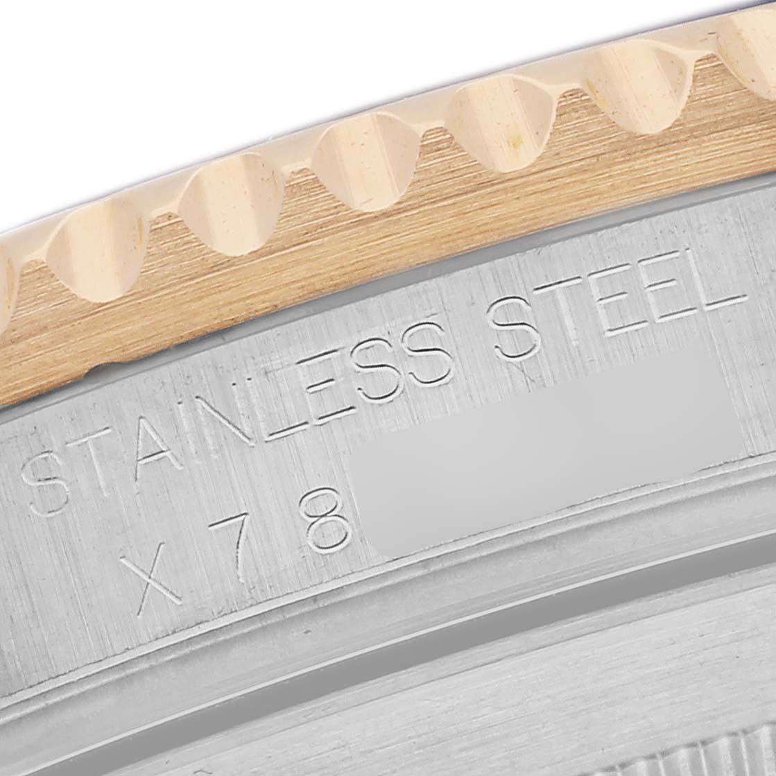 This image shows a detailed view of the engraved side of the case and bezel of a Rolex Submariner 16613 Men's Steel and Gold (two tone) Grey Dial 16613 Men's Steel and Gold (two tone) Grey Dial watch.