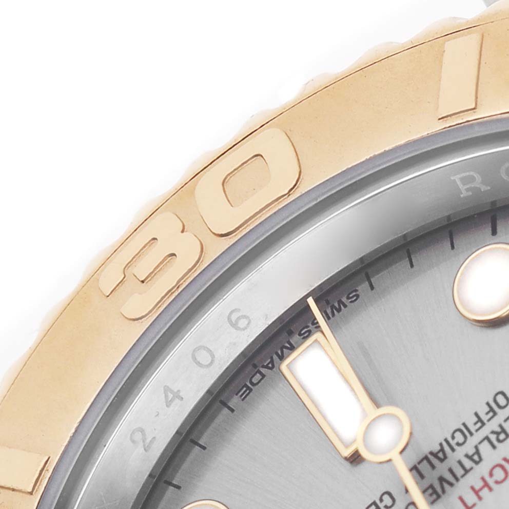 The image shows a close-up of the Rolex Yacht-Master 16623 Men's Steel and Gold (two tone) Silver Dial watch's bezel and part of the dial.