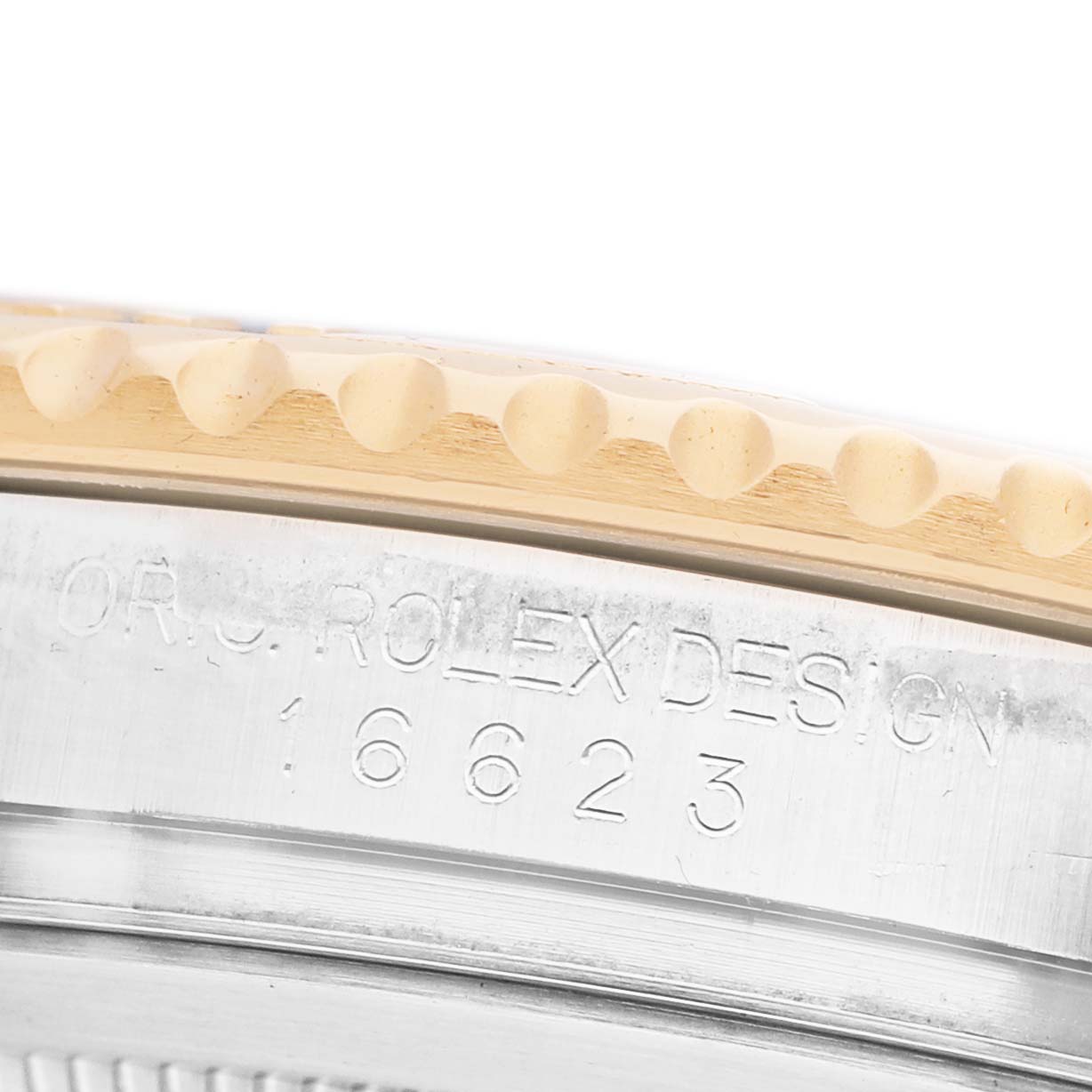 The image shows a close-up of the bezel and engraved edge of the Rolex Yacht-Master 16623 Men's Steel and Gold (two tone) Silver Dial watch.