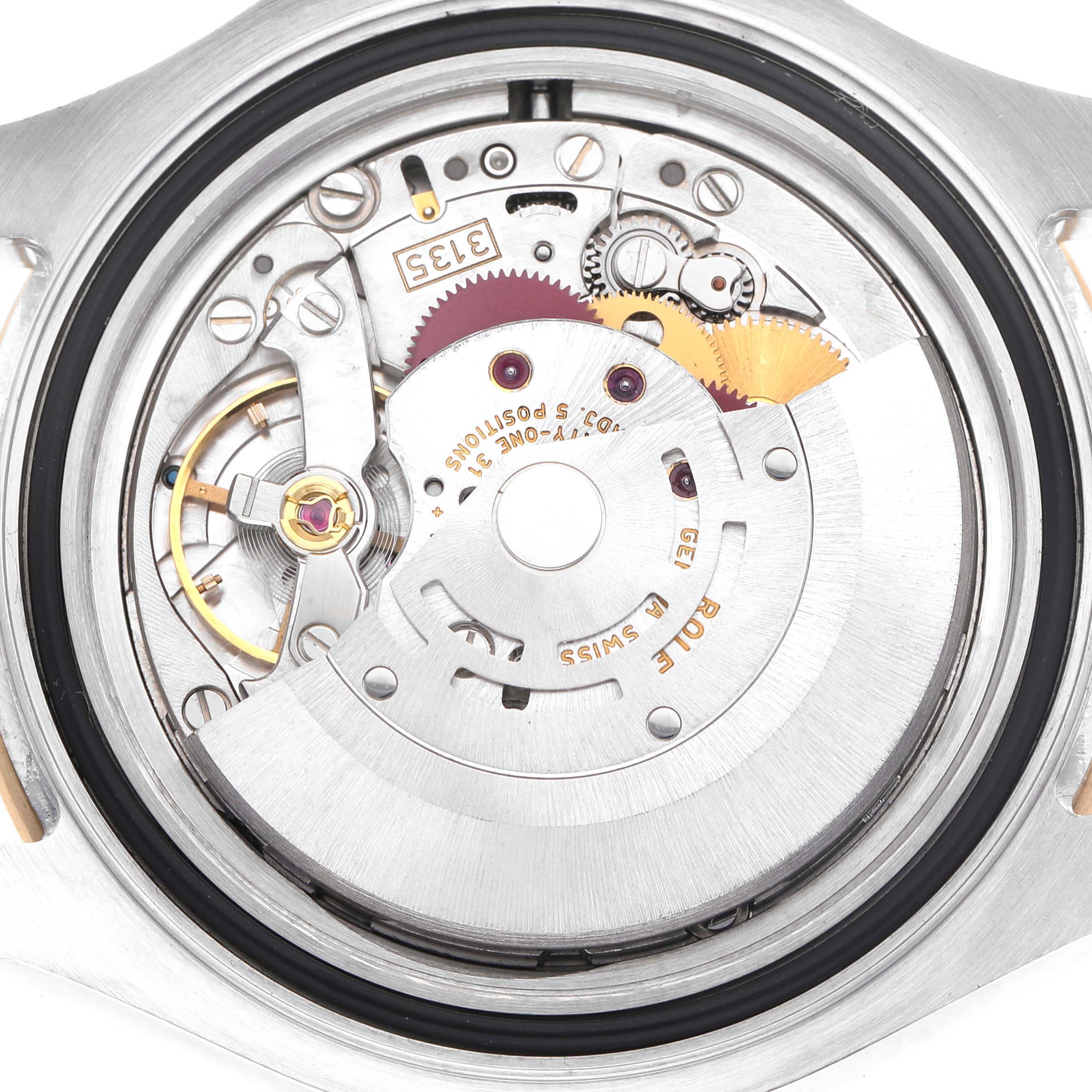 The image shows the movement of a Rolex Yacht-Master 16623 Men's Stainless Steel White Dial watch, highlighting gears and mechanical components from the back.