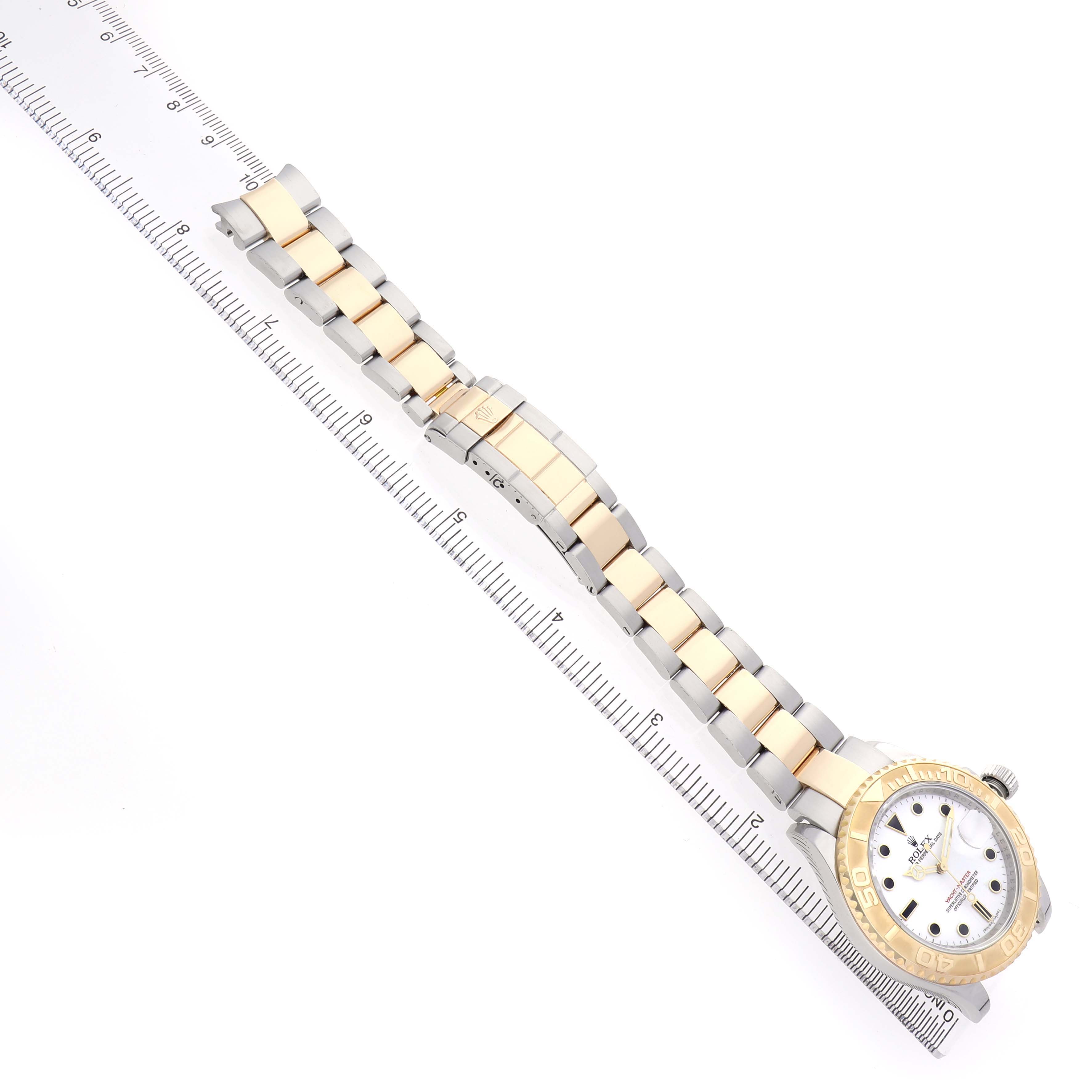 The Rolex Yacht-Master 16623 Men's Stainless Steel White Dial watch is shown from a top-down angle, displaying the full bracelet and dial alongside a ruler for scale.