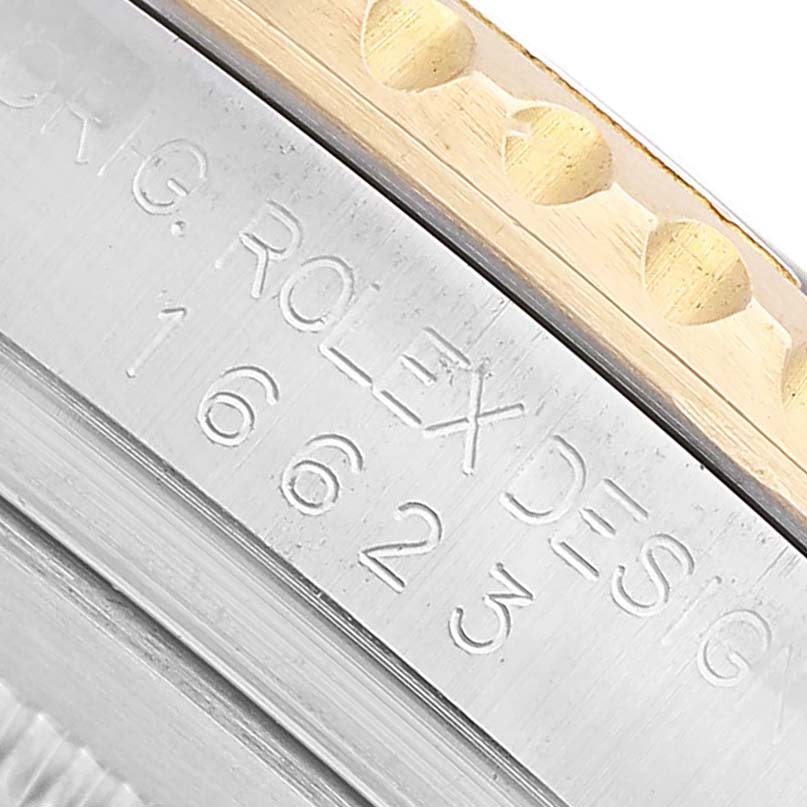 The image shows a close-up of the bezel and engraved side of a Rolex Yacht-Master 16623 Men's Stainless Steel White Dial watch.