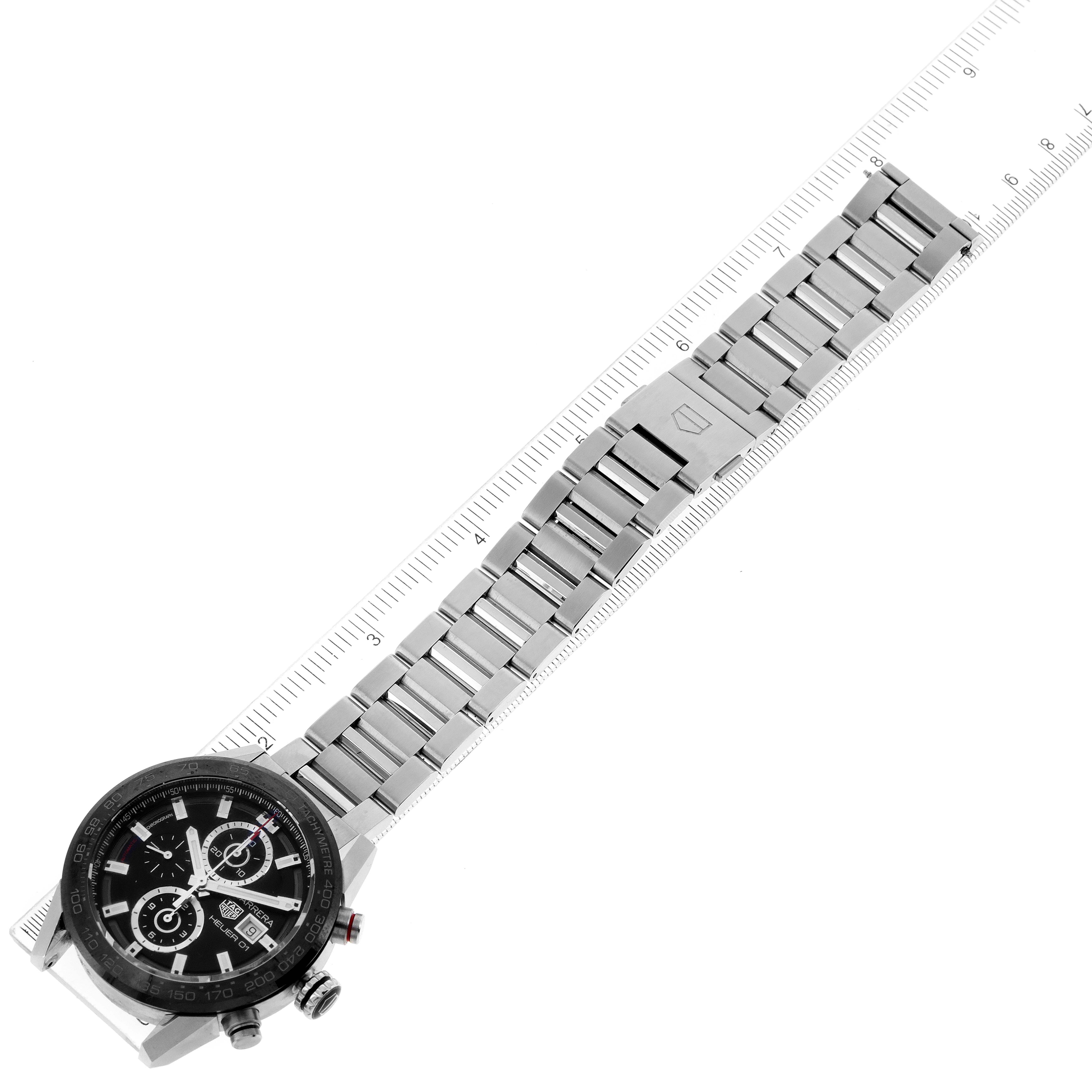 The image shows a Tag Heuer Carrera CAR201Z.BA0714 Men's Stainless Steel Black Dial CAR201Z.BA0714 Men's Stainless Steel Black Dial watch from a top-down angle, highlighting the face and stainless steel bracelet with a ruler measuring the length.