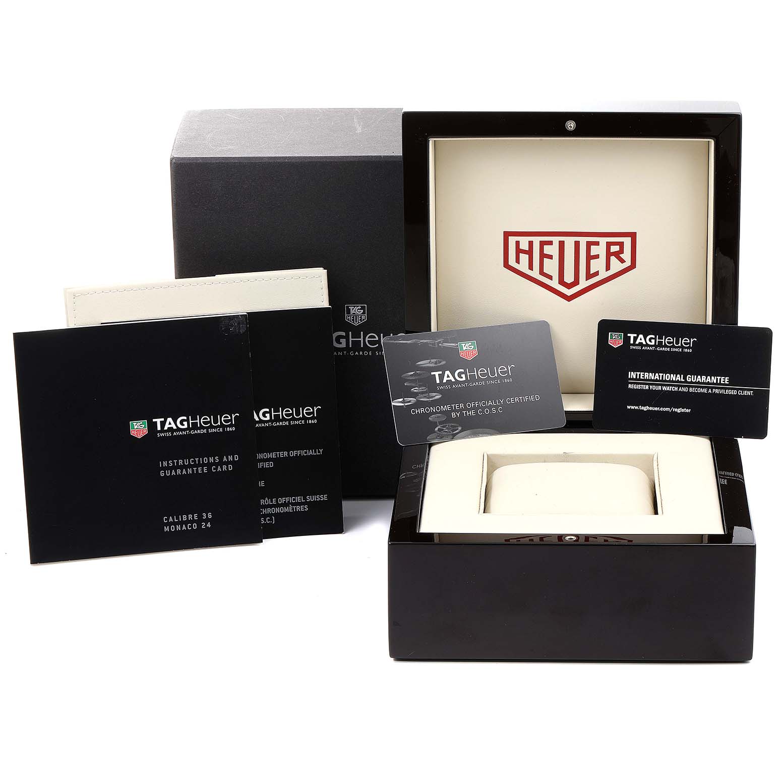 The image shows the packaging, instruction manuals, and guarantee cards for the Tag Heuer Monaco CAL5112.FC6298 Men's Stainless Steel Grey Dial CAL5112.FC6298 Men's Stainless Steel Grey Dial watch.
