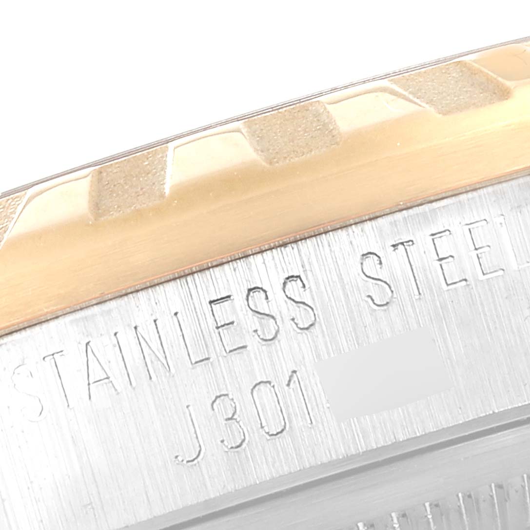 This image shows a close-up of the stainless steel case back of a Tudor Classic 22013 Women's Steel and Gold (two tone) Champagne Dial 22013 Women's Steel and Gold (two tone) Champagne Dial model watch, including part of the bezel.