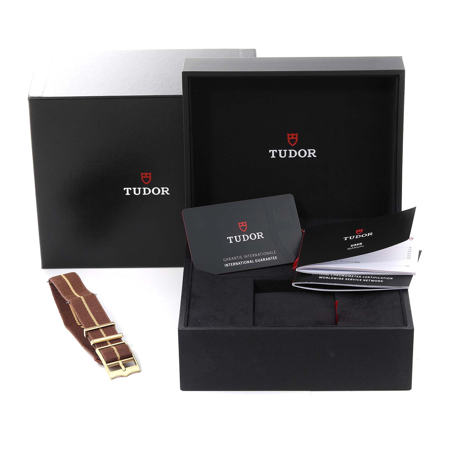 This image shows the packaging and accessories of a Tudor Heritage Black Bay M79012M-0001 Men's Bronze Brown Dial M79012M-0001 Men's Bronze Brown Dial watch, including the box, manual, and warranty card.