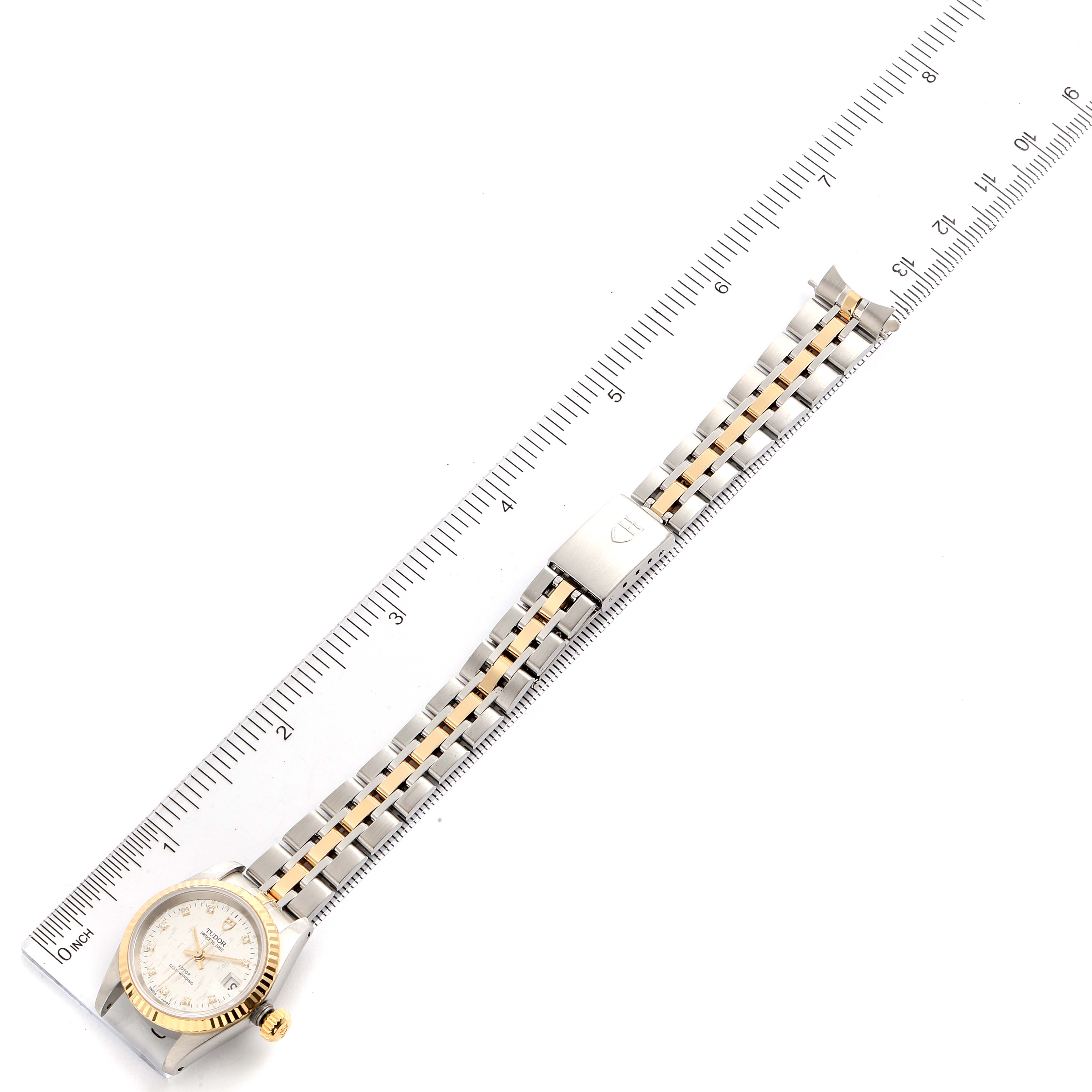 The Tudor Princess 92413 Women's Steel and Gold (two tone) Silver Dial 92413 Women's Steel and Gold (two tone) Silver Dial watch is photographed laying flat with its entire face, bracelet, and clasp visible alongside a ruler for scale.