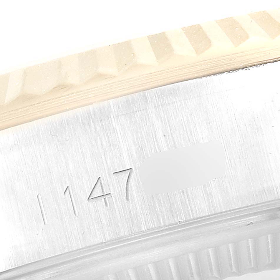 This image shows a close-up of the Tudor Princess 92413 Women's Steel and Gold (two tone) Silver Dial 92413 Women's Steel and Gold (two tone) Silver Dial watch case, focusing on the serial number and the bezel.