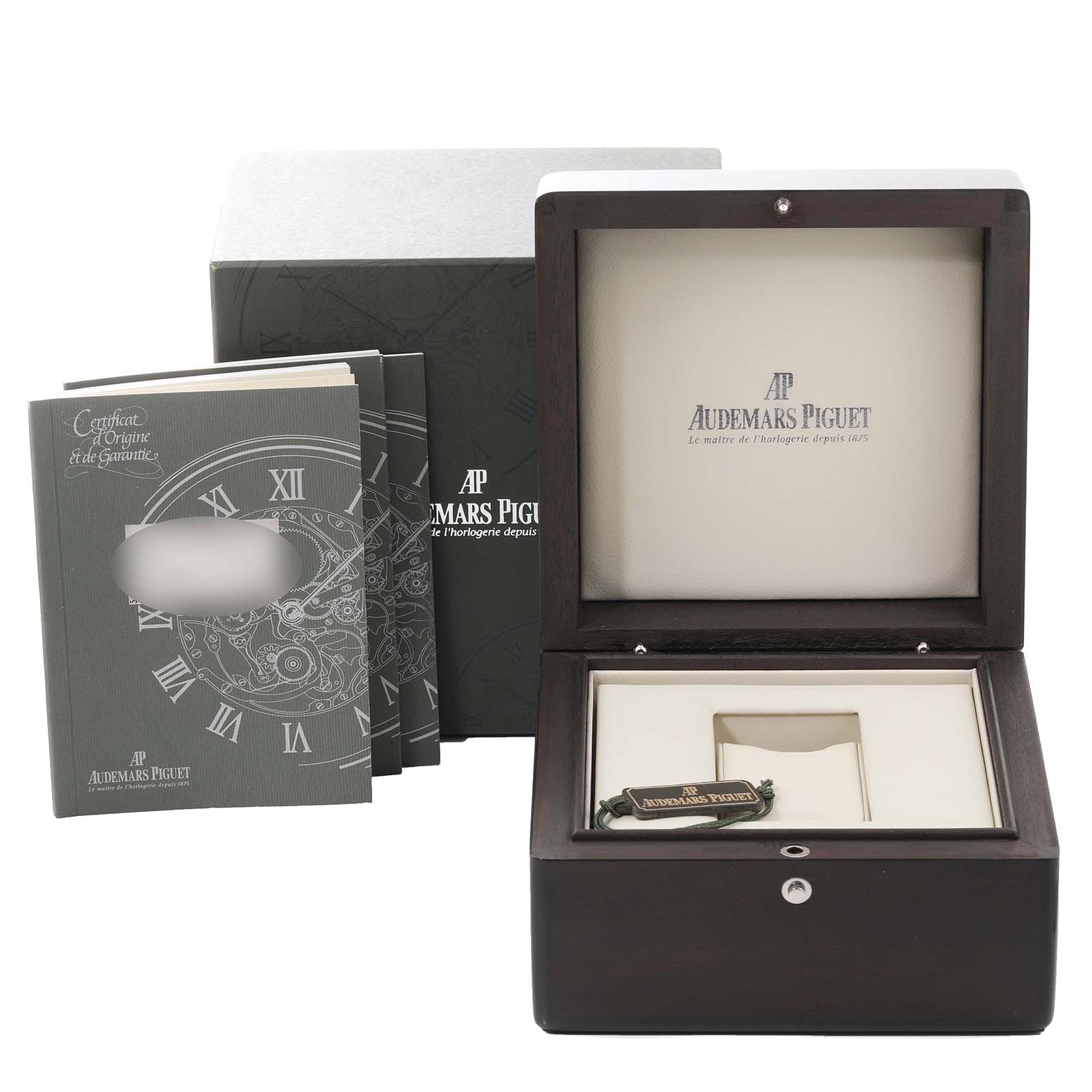 The image shows the packaging, manuals, and box for a Royal Oak model by Audemars Piguet.