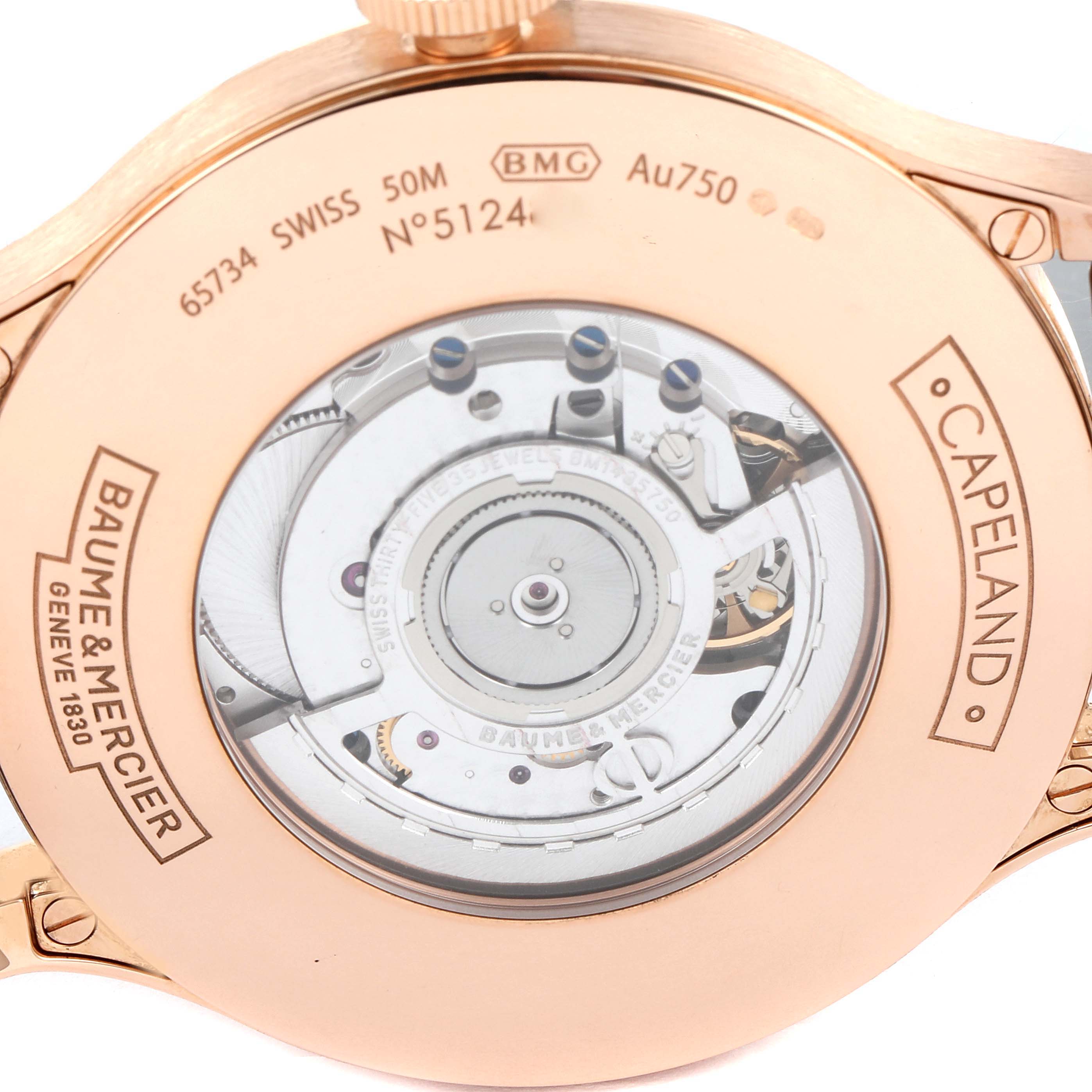The image shows the rear view of the Capeland watch by Baume & Mercier, highlighting its exposed movement and engravings.
