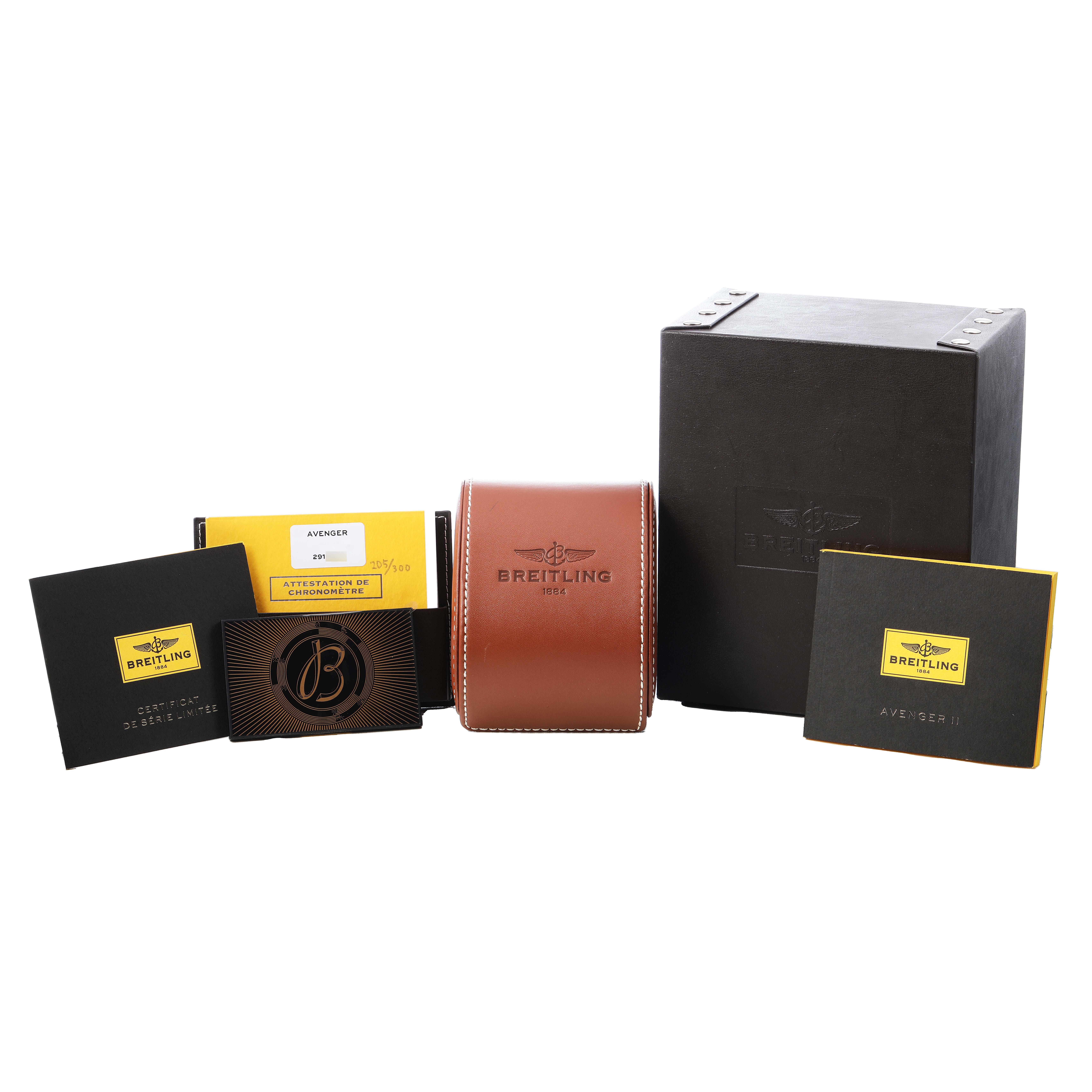 The image shows the Breitling Avenger A13381 Men's Stainless Steel White Dial model's accessories, including a leather case, box, and various documents, from a frontal angle.