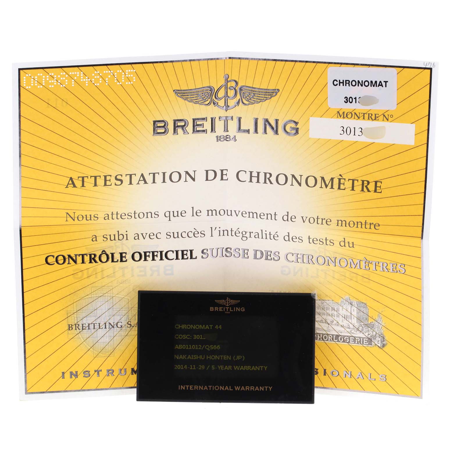 The image shows a Chronomat model by Breitling certification and an international warranty card.
