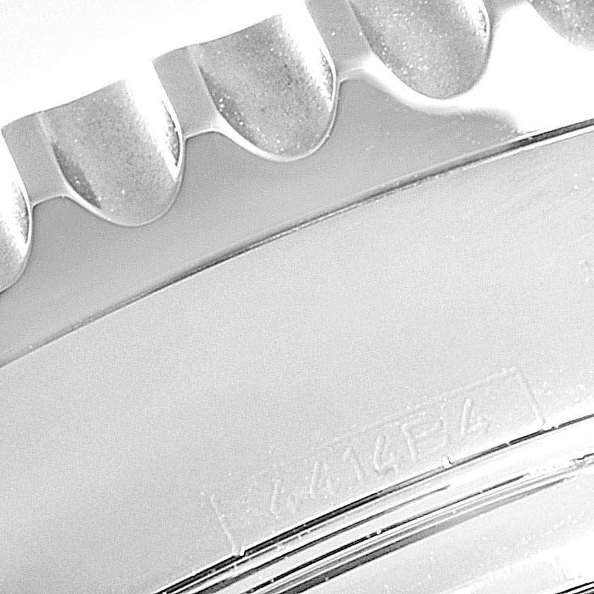 This close-up image of the Breitling Navitimer AB0120 Men's Stainless Steel Black Dial AB0120 Men's Stainless Steel Black Dial watch shows a detailed view of the bezel and part of the casing.