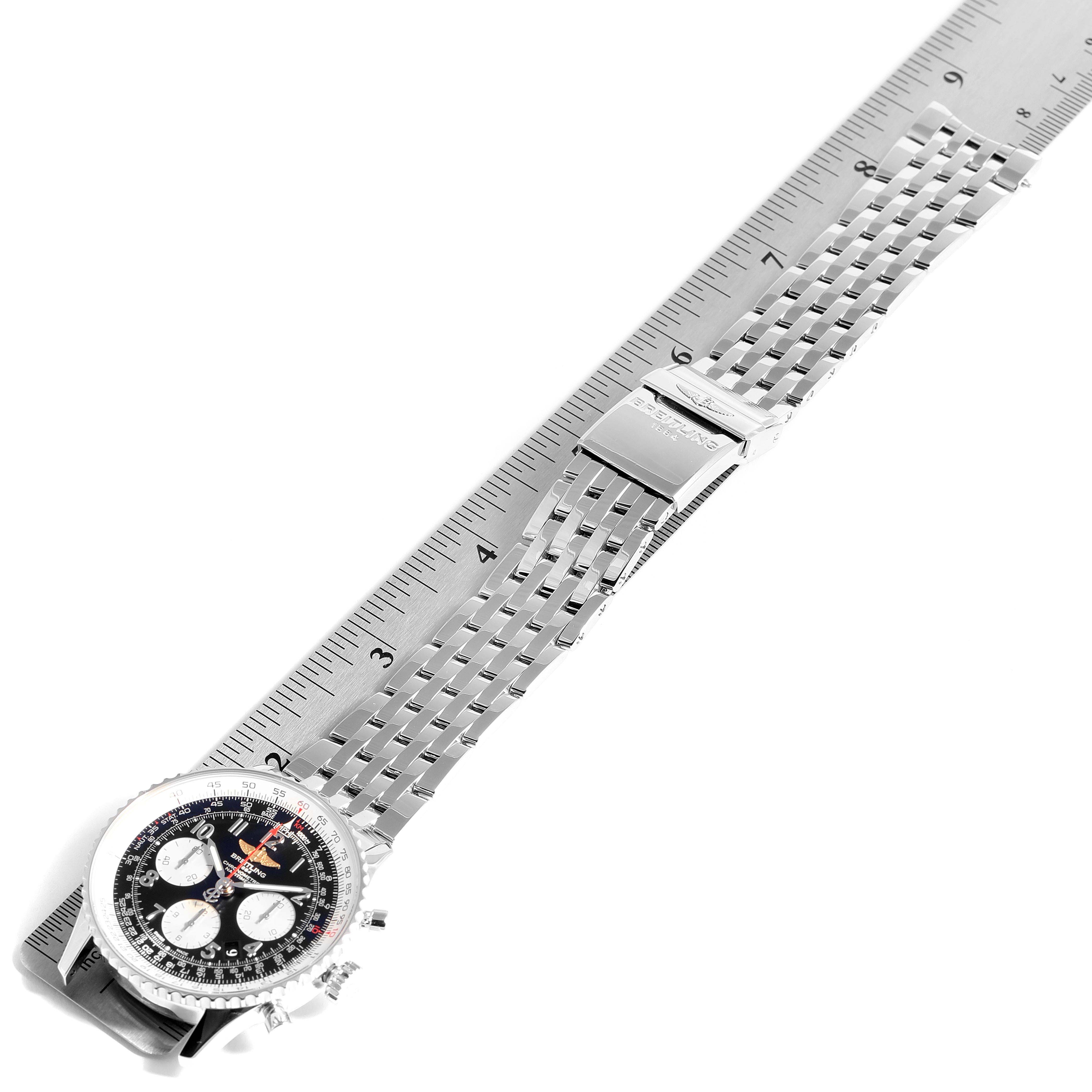 This image shows an overhead view of a Breitling Navitimer AB0120 Men's Stainless Steel Black Dial AB0120 Men's Stainless Steel Black Dial watch with a stainless steel bracelet laid out flat next to a ruler.