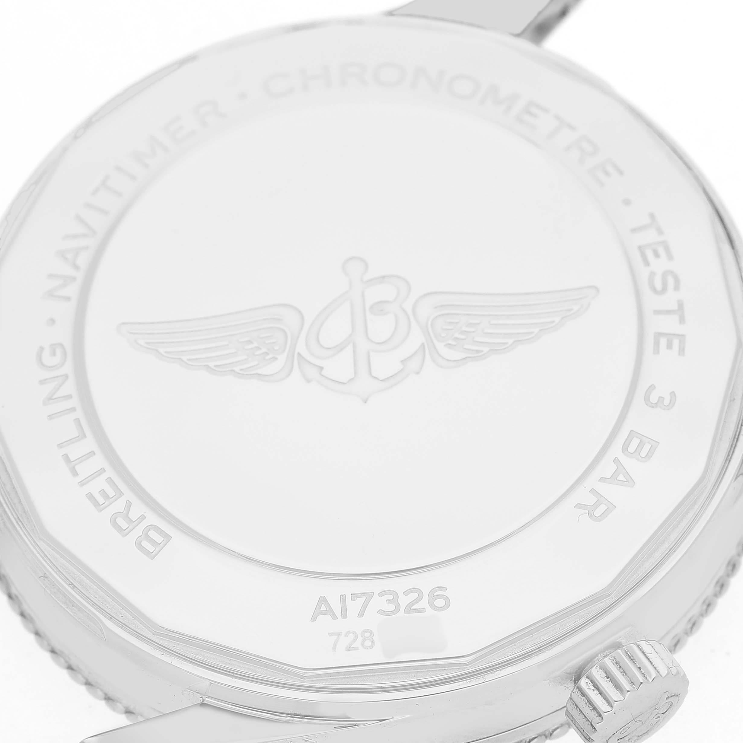 The image shows the back case of a Breitling Navitimer A17326 Men's Stainless Steel Black Dial watch, highlighting its emblem and model details from a top angle.