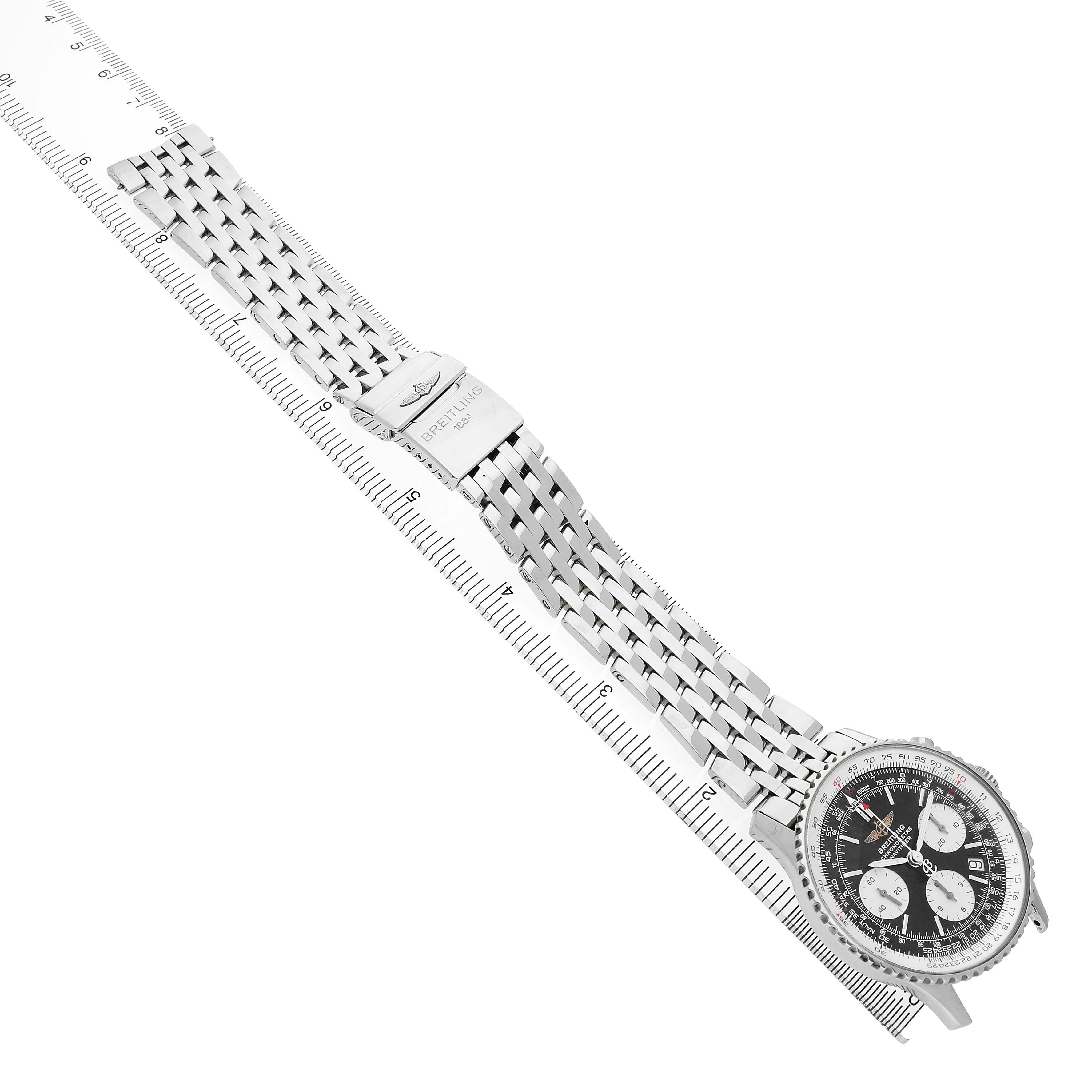 The image shows a side view of a Breitling Navitimer A23322 Men's Stainless Steel Black Dial watch with its full metal bracelet and clasp extended over a ruler.