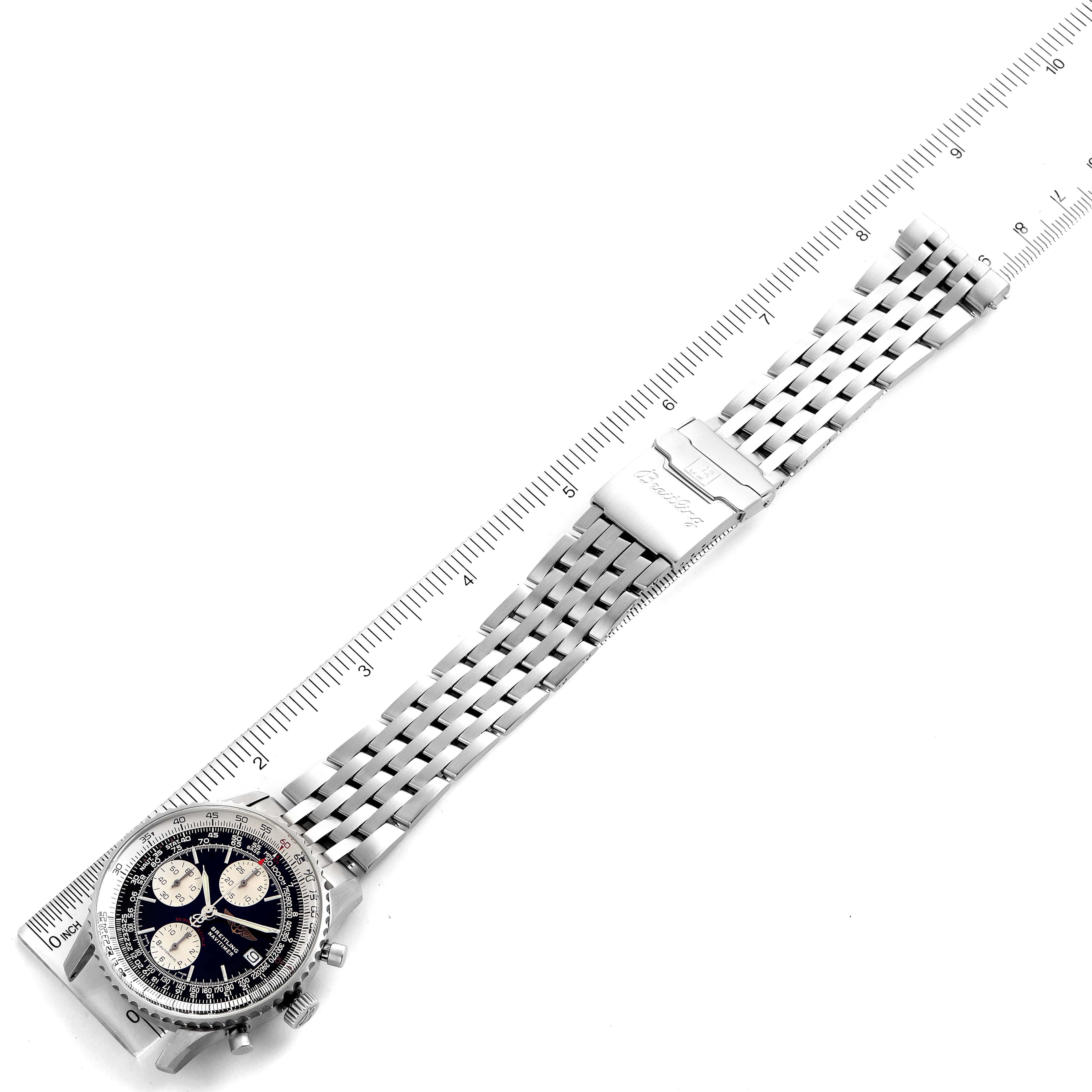 The Breitling Navitimer A13330 Men
s Stainless Steel Black Dial A13330 Men
s Stainless Steel Black Dial watch is shown from an angled top view, displaying the face, dial, and wristband beside a ruler.