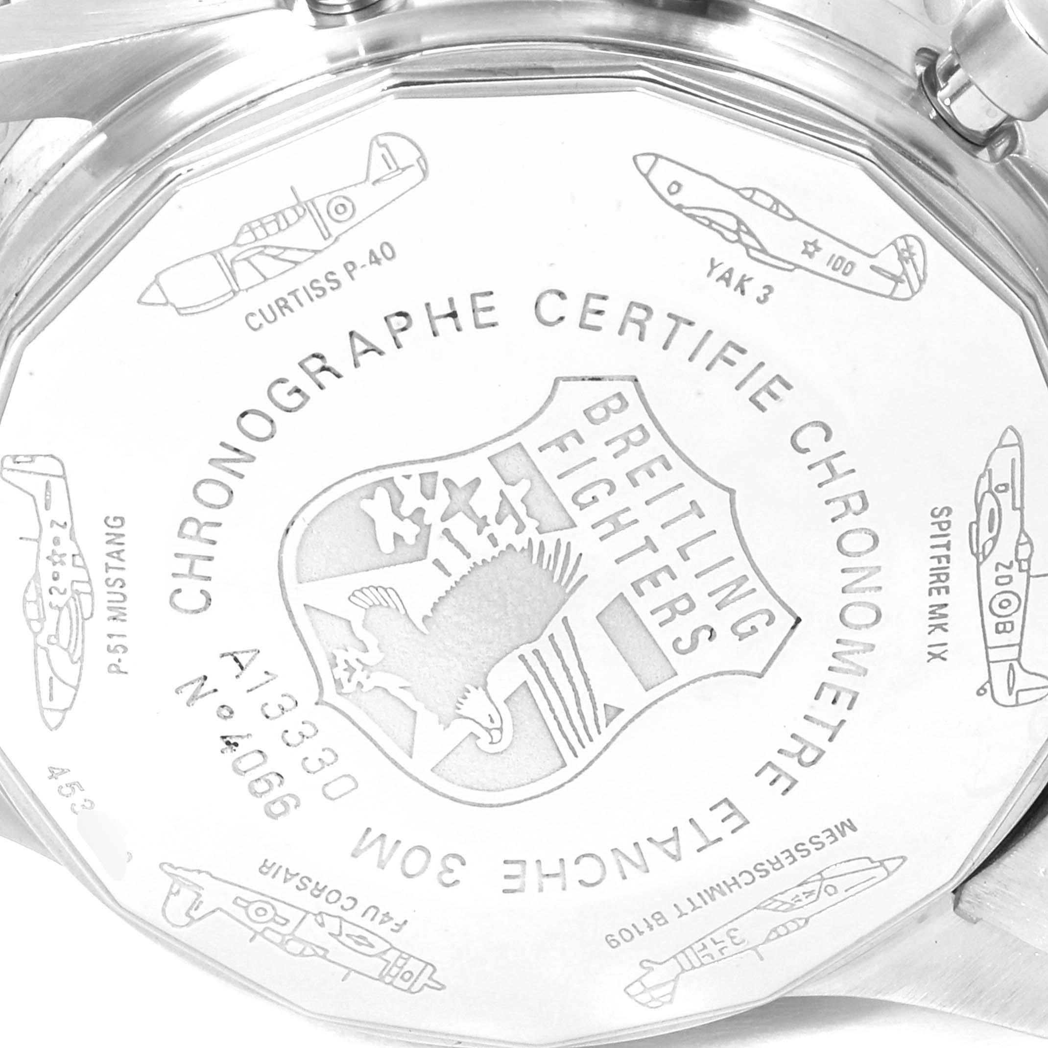 The image shows the back case of a Breitling Navitimer A13330 Men
s Stainless Steel Black Dial A13330 Men
s Stainless Steel Black Dial watch, displaying various engraved fighter plane illustrations and inscriptions.