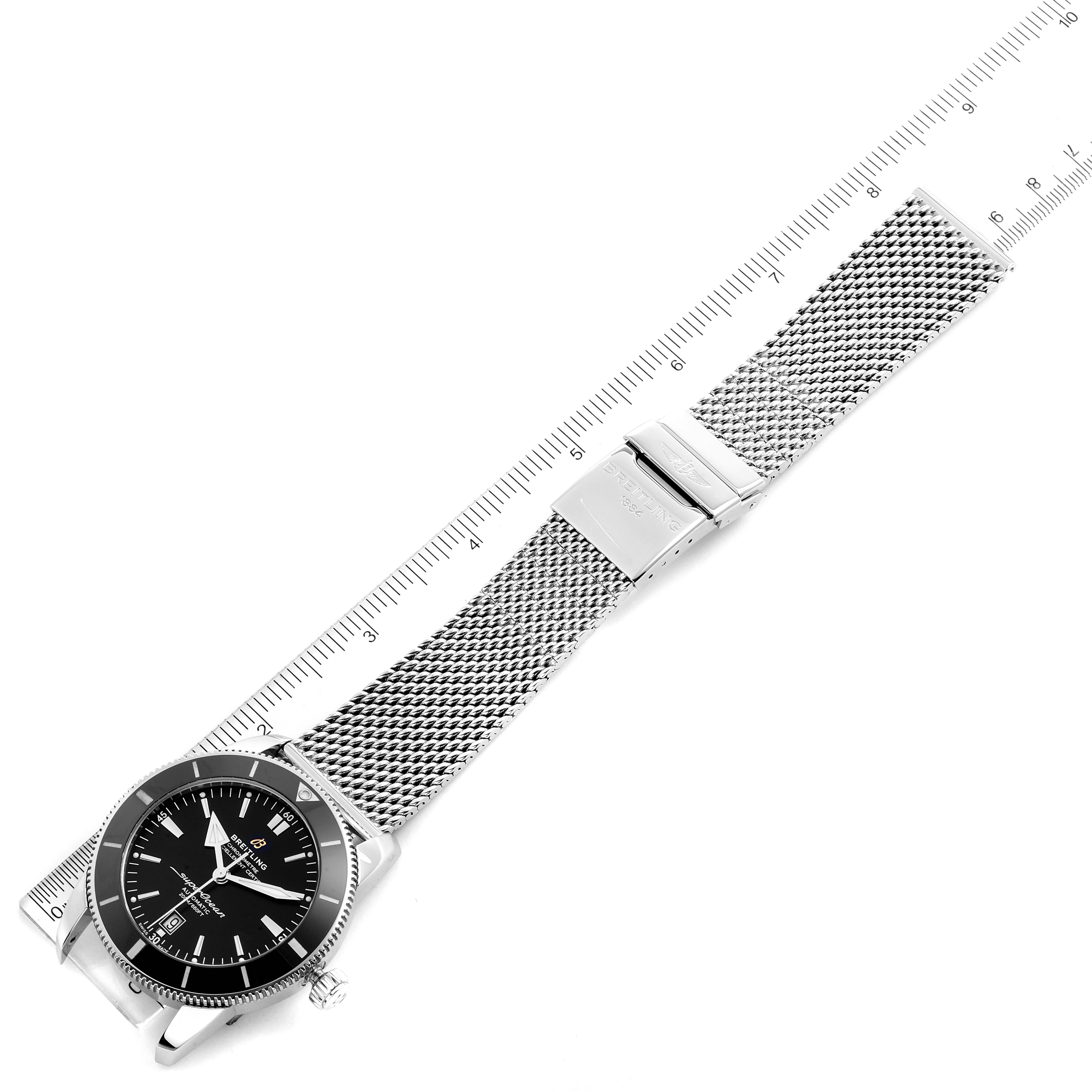 The image shows a Breitling Superocean AB202016-C961-152A Men
s Stainless Steel Black Dial AB202016-C961-152A Men
s Stainless Steel Black Dial watch laid flat with a mesh bracelet, positioned next to a ruler for scale.