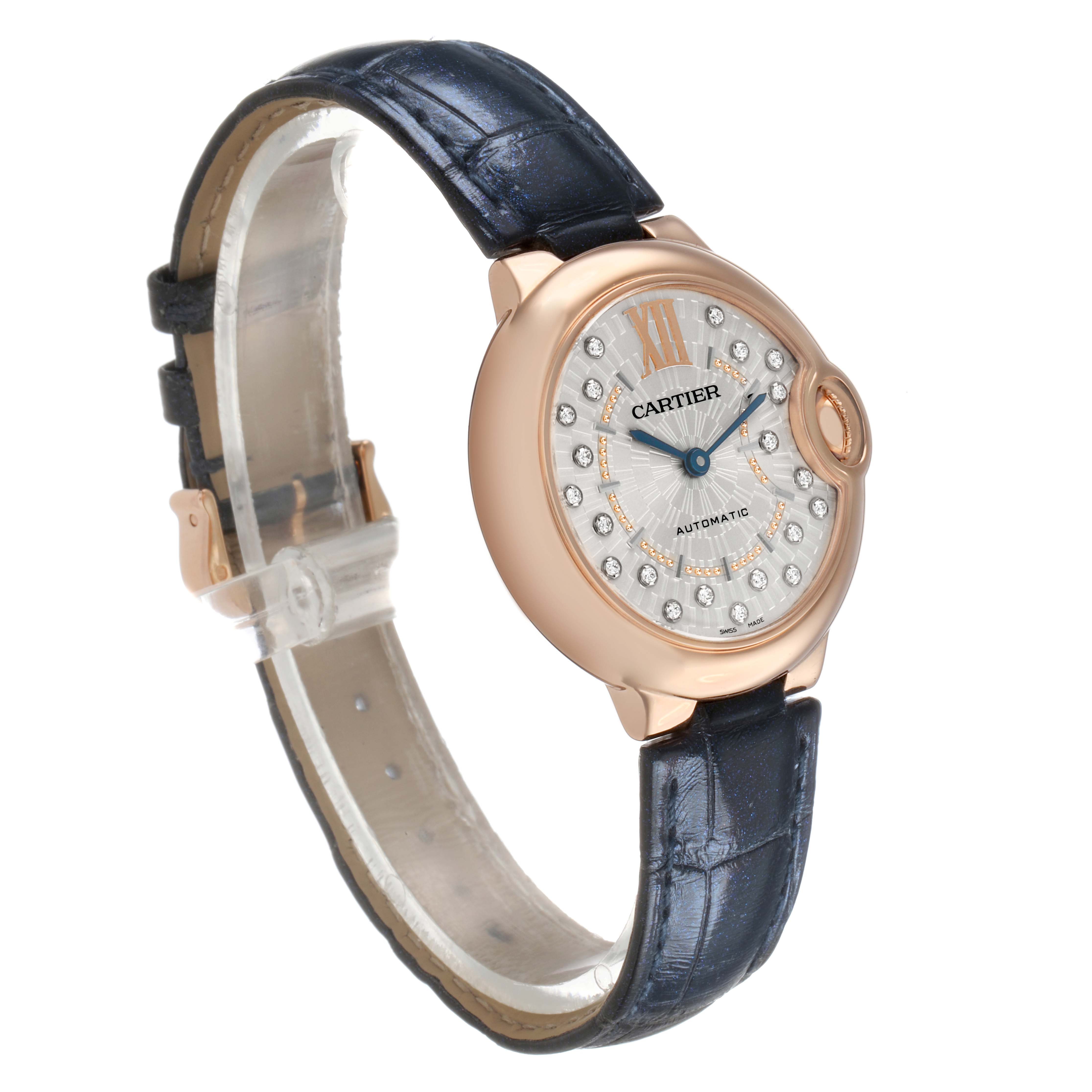 The Ballon Bleu by Cartier is shown at a slight angle, highlighting the face, bezel, and strap, with visible Roman numerals and diamond markers.