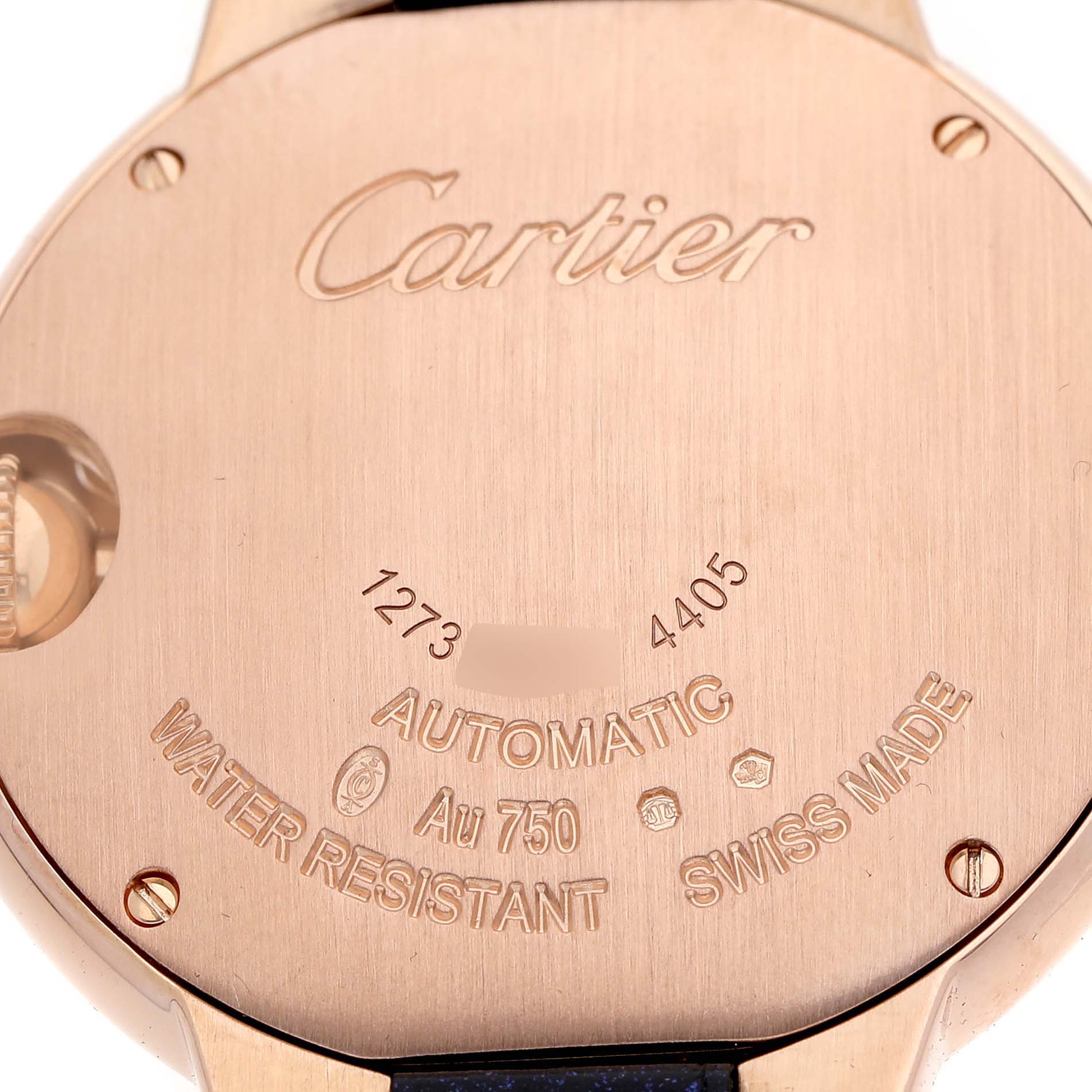 The image shows the case back of a Ballon Bleu de Cartier watch, highlighting its inscriptions and screws.