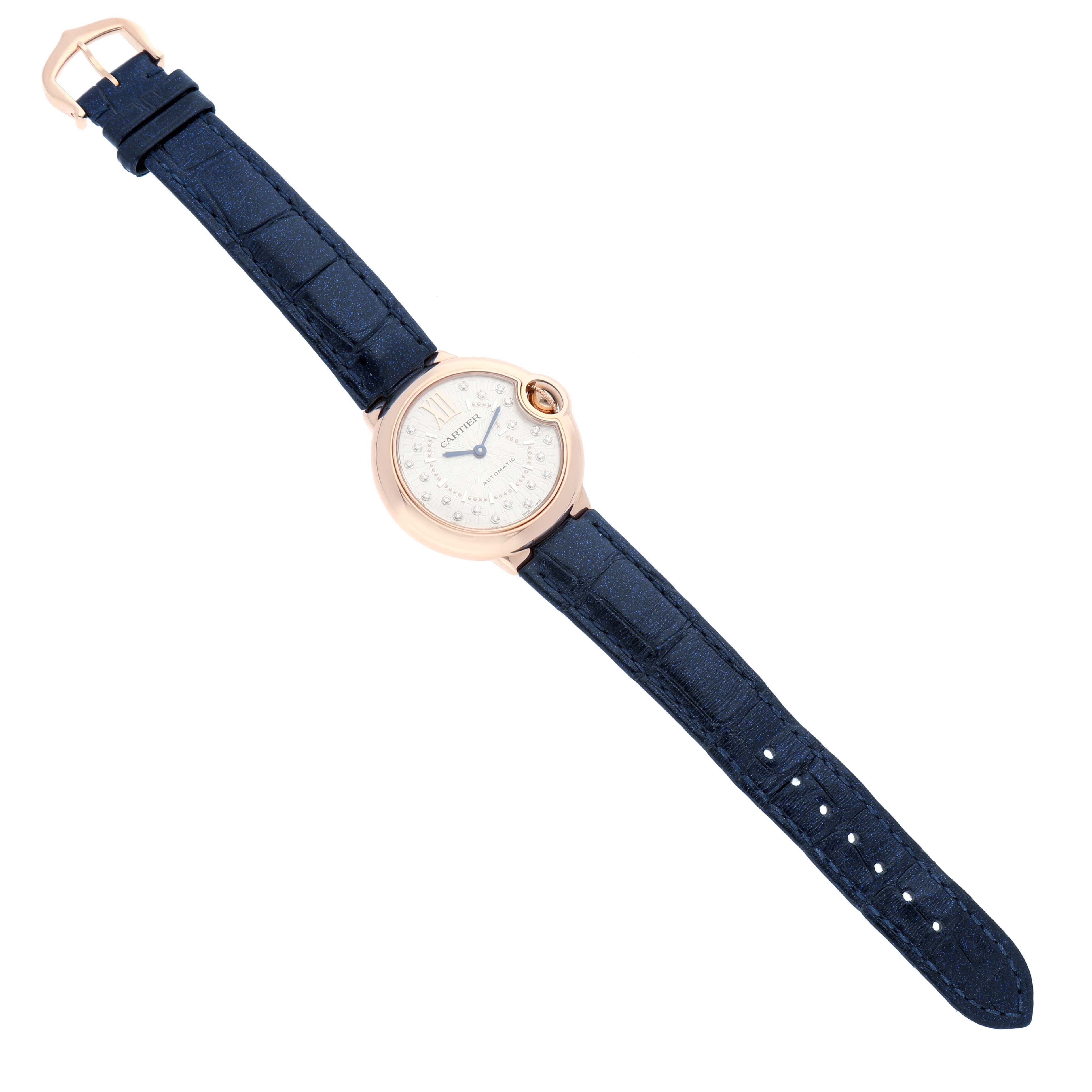 The Cartier Ballon Bleu WGBB0052 Women's Rose Gold Silver Dial watch is shown from a top-down angle, featuring a round case, silver dial, and a blue leather strap.