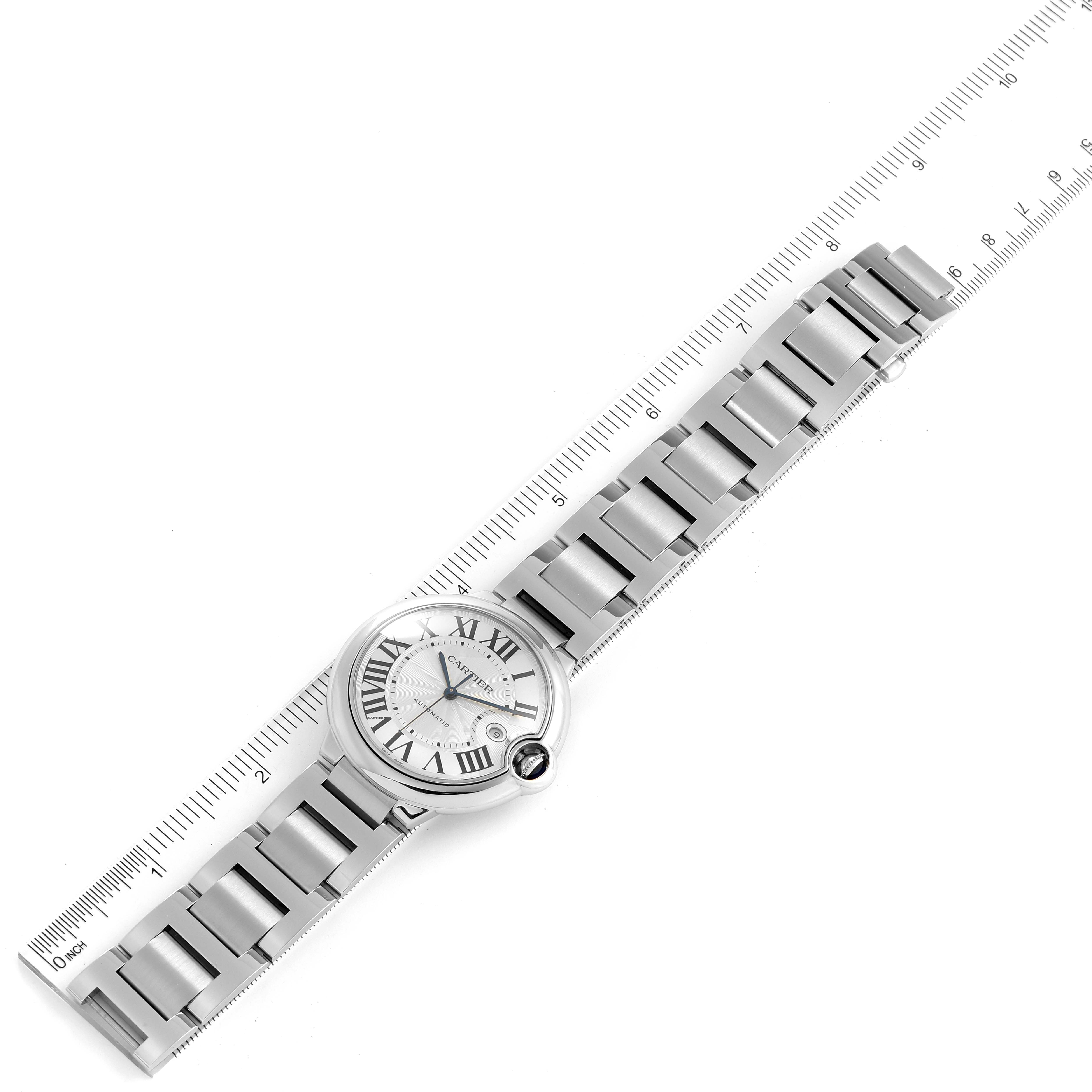 The image shows a Cartier Ballon Bleu W69012Z4 Men
s Stainless Steel Silver Dial W69012Z4 Men
s Stainless Steel Silver Dial watch laid flat with a ruler for scale, displaying the watch face and stainless steel bracelet.