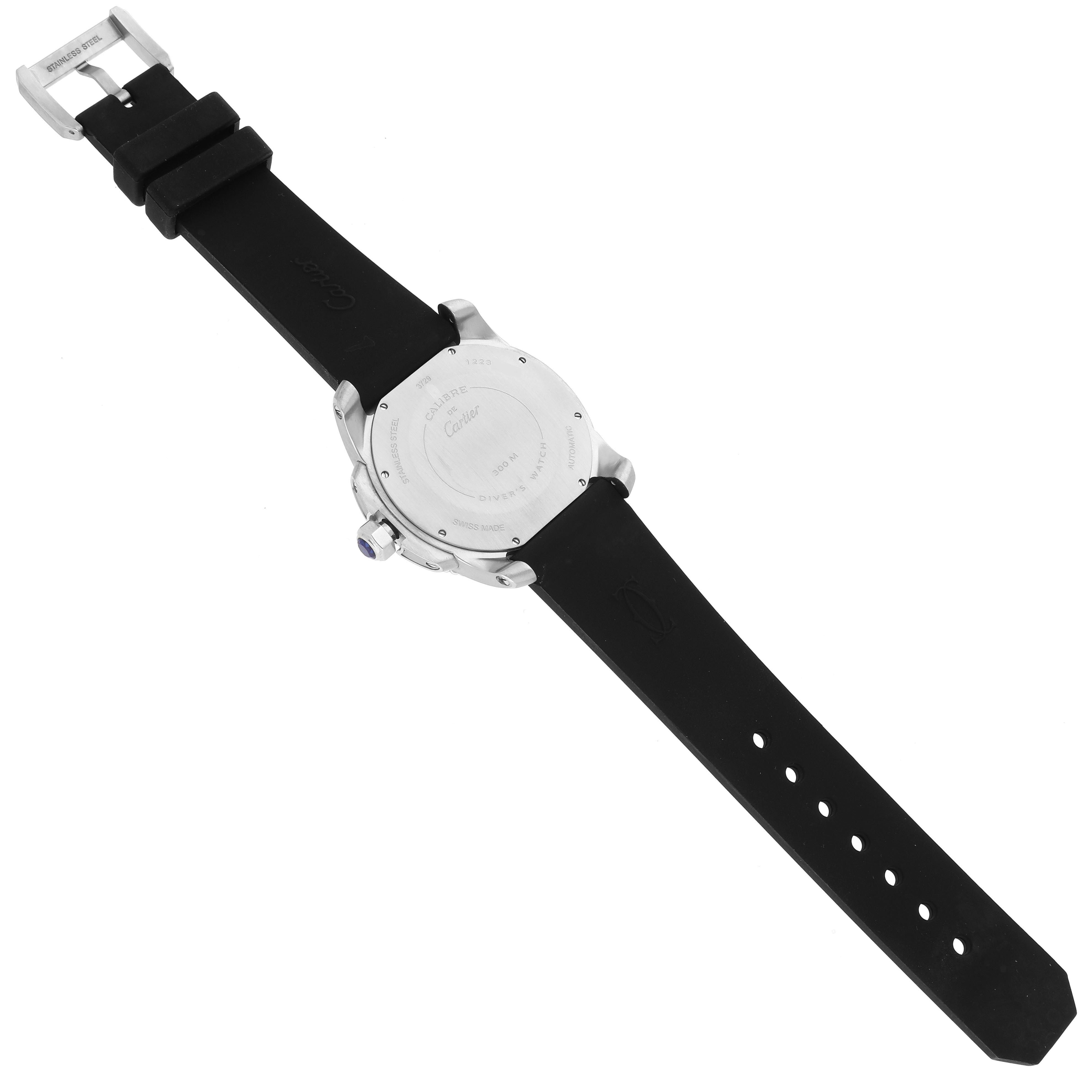 The image shows the back view of the Calibre de Cartier watch by Cartier, including the case back and rubber strap.