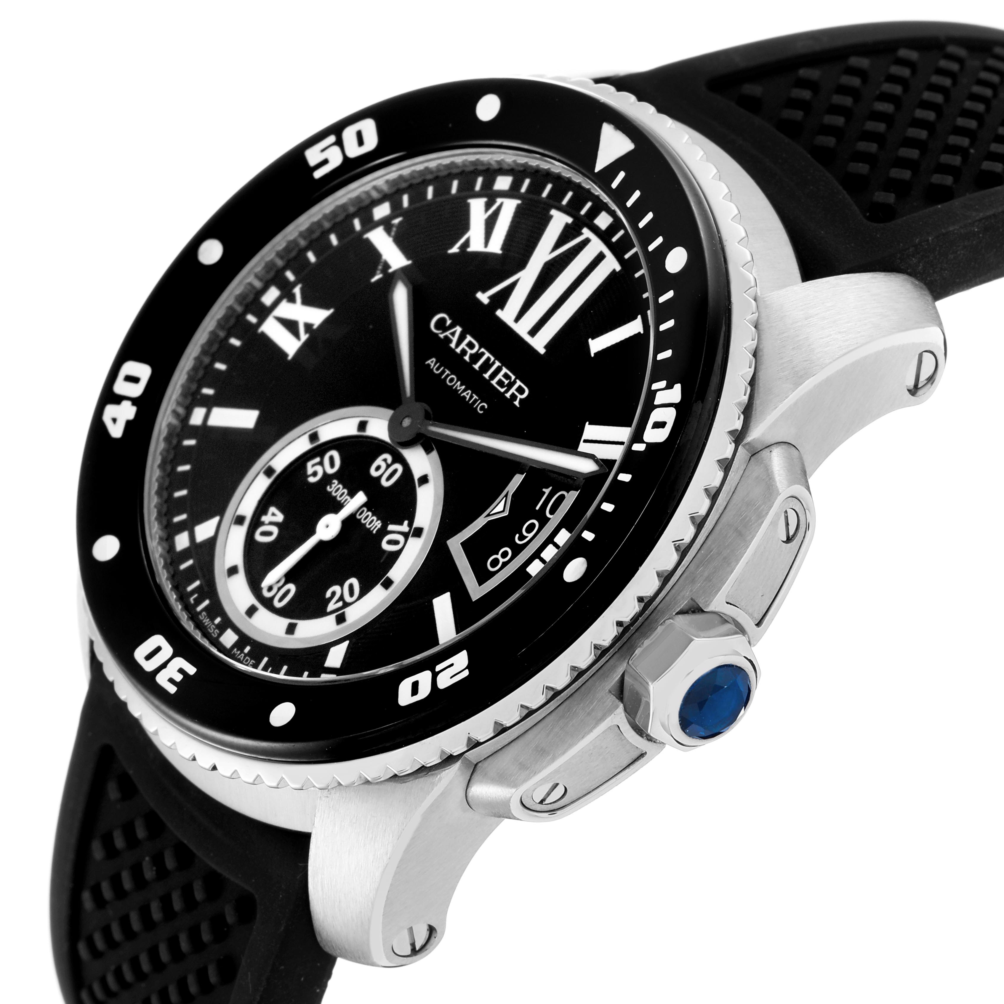 The Calibre de Cartier watch is shown at an angle highlighting the bezel, crown, and subdial with a rubber strap.