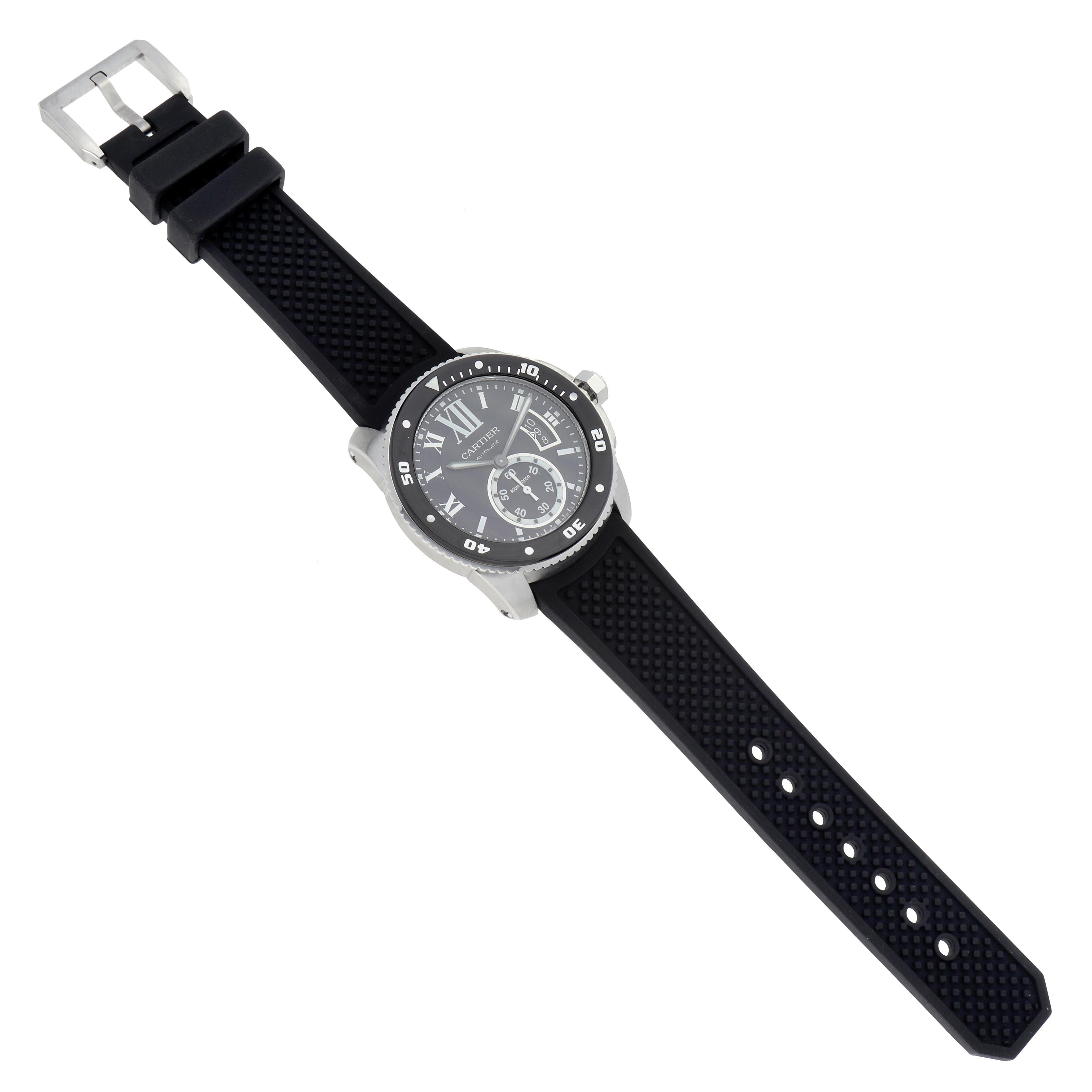 The Calibre de Cartier watch is shown from a top view, displaying the face, bezel, and full strap with its buckle.