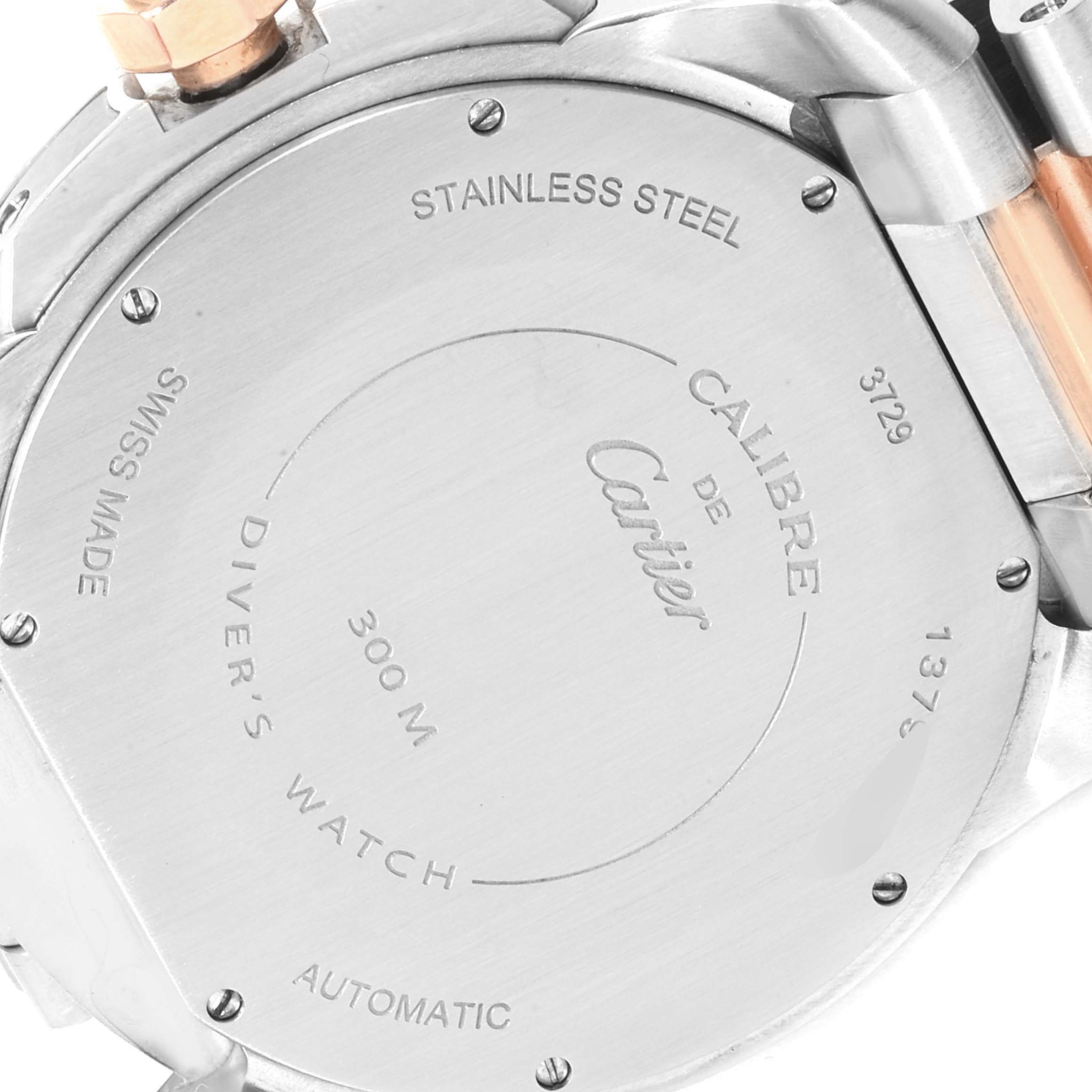 The image shows the back of a Calibre de Cartier watch, showcasing the stainless steel case and engraved details.