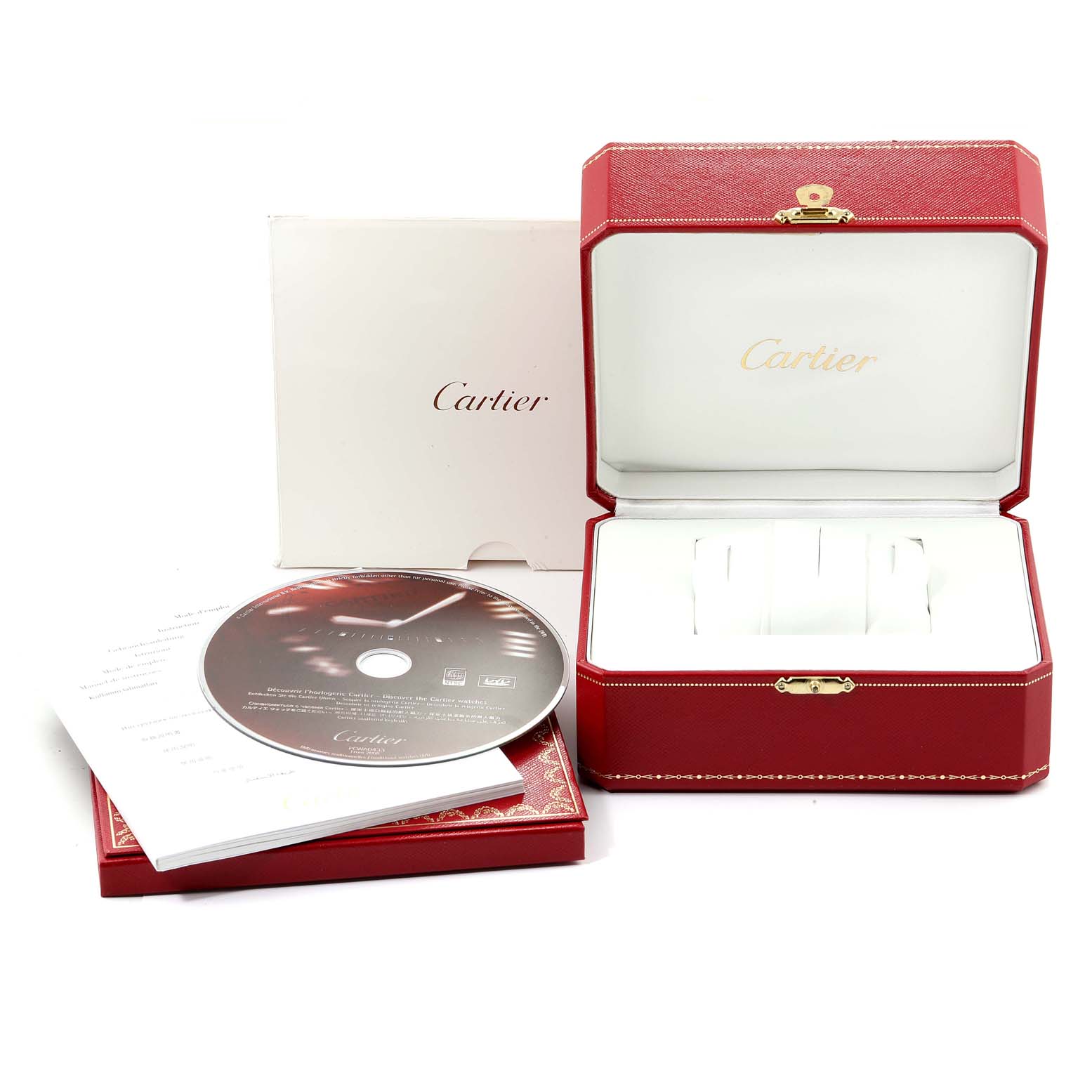 This image shows a Cartier Roadster W62041V3 Men
s Stainless Steel Black Dial W62041V3 Men
s Stainless Steel Black Dial watch box, a CD, and documentation, taken from an overhead angle.