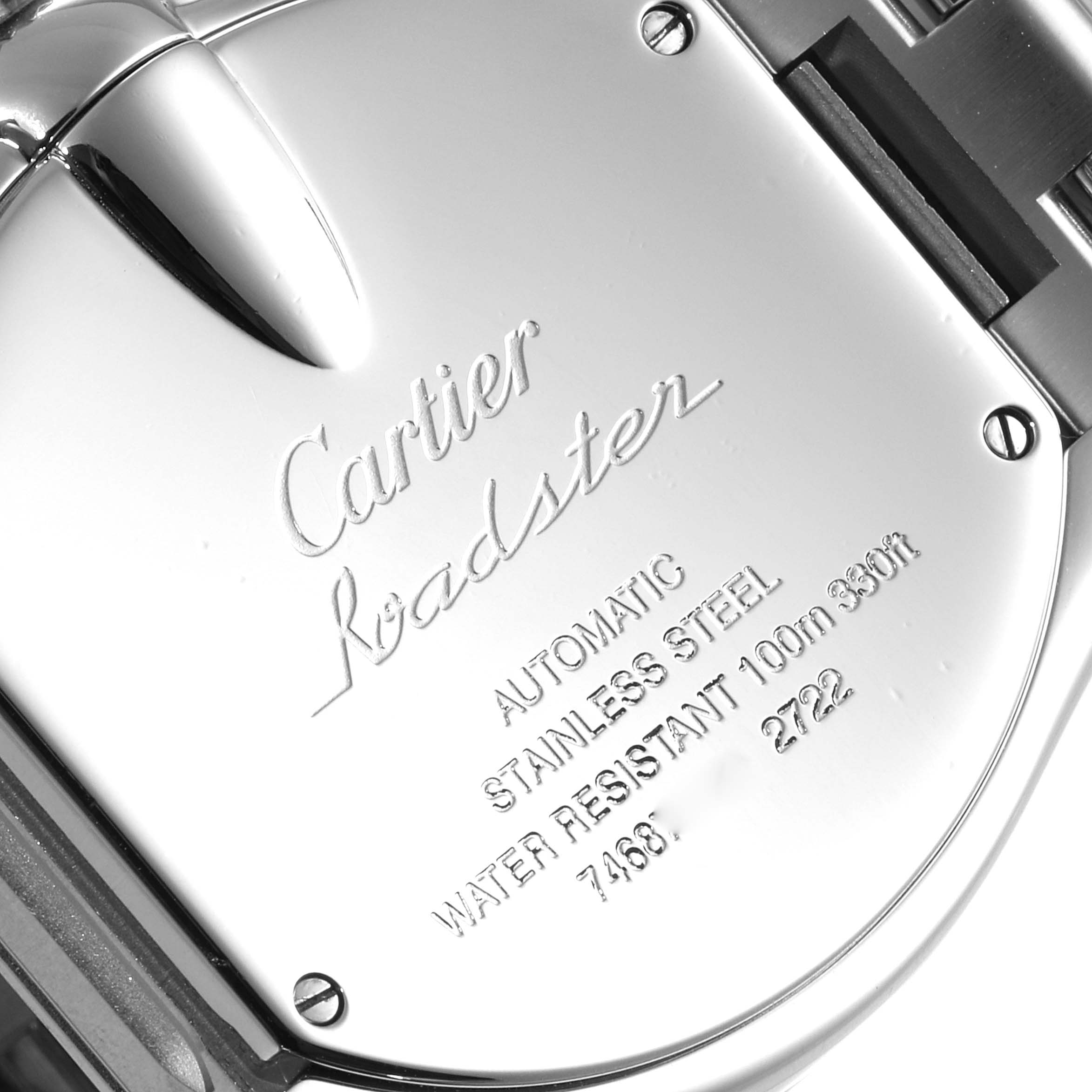The image shows the back of a Cartier Roadster W62032X6 Men
s Stainless Steel Silver Dial W62032X6 Men
s Stainless Steel Silver Dial watch, featuring engraving details on the stainless steel case.