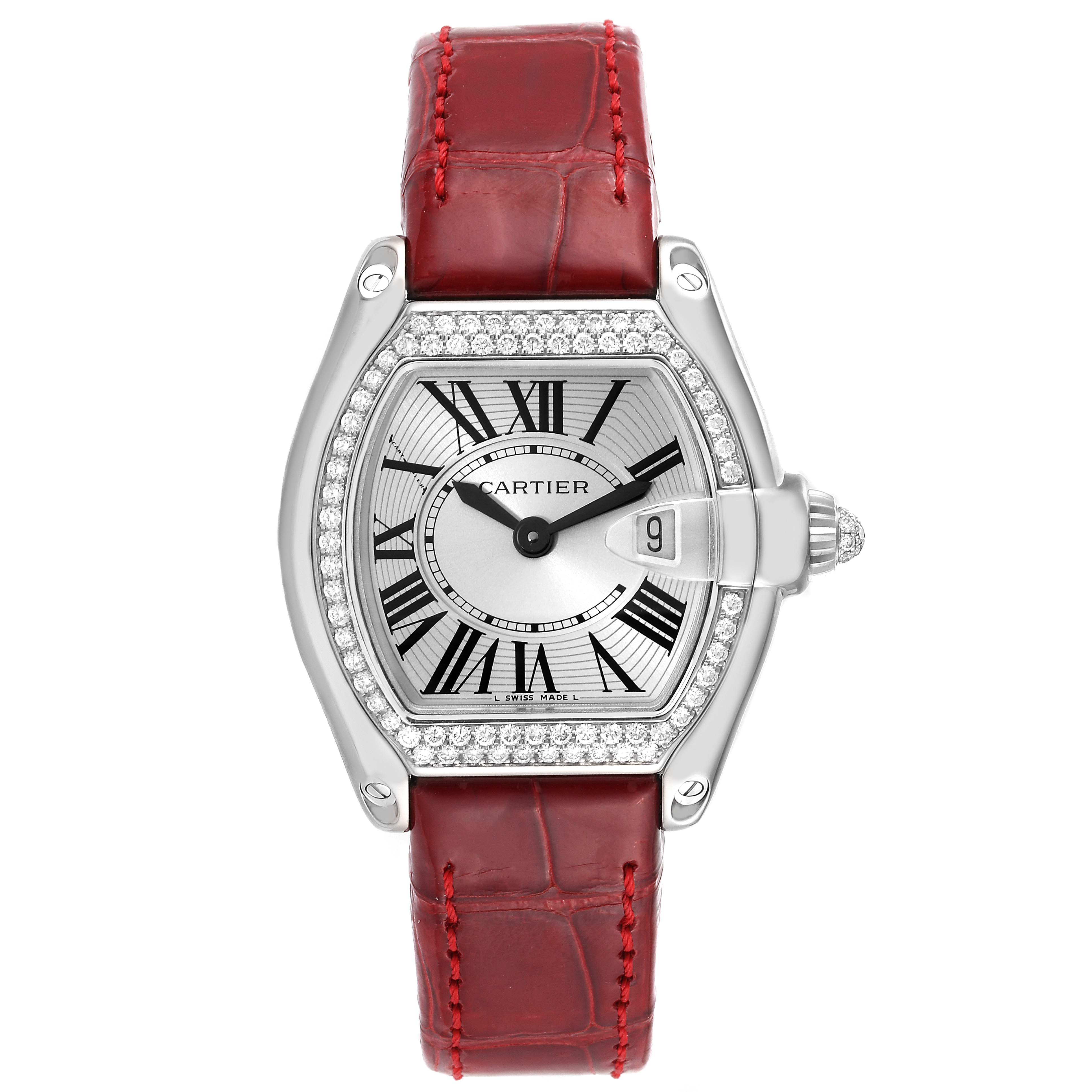 The Cartier Roadster WE500260 Women's White Gold Silver Dial WE500260 Women's White Gold Silver Dial watch is shown from a top-down angle, displaying its face, bezel, and red leather strap.
