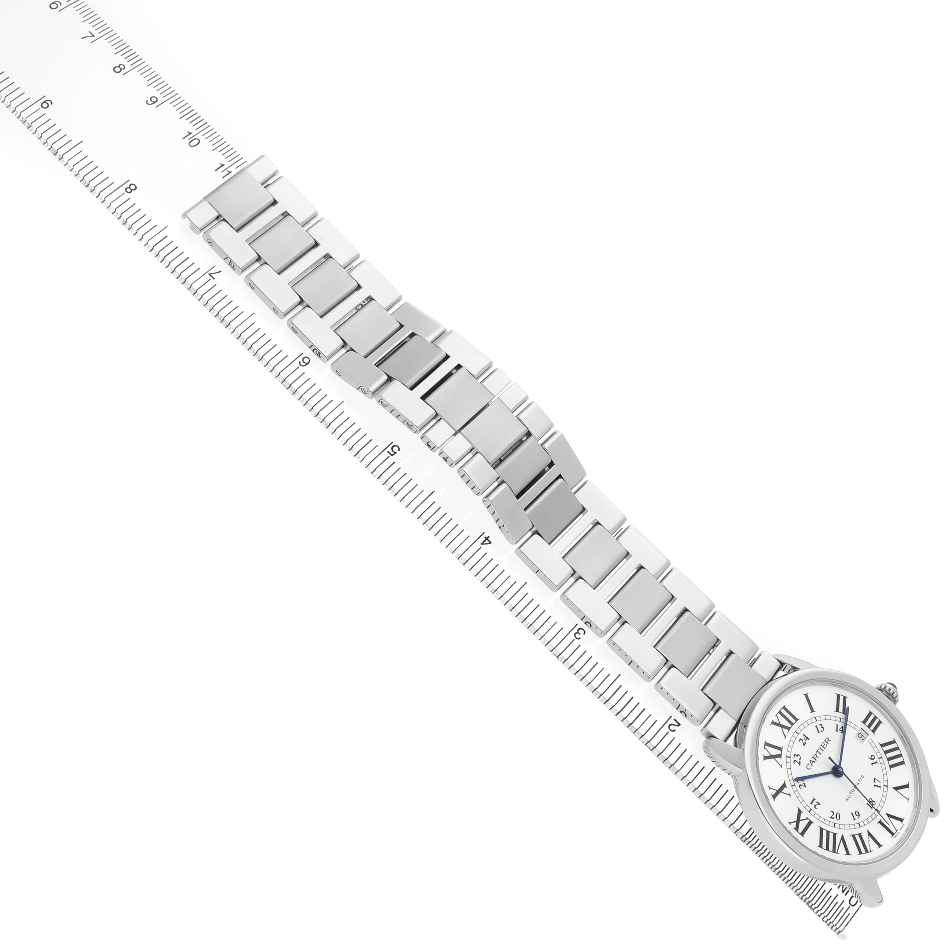 The Cartier Ronde W6701011 Men's Stainless Steel Silver Dial watch is shown from above, displaying its face, bracelet, and a ruler for size reference.