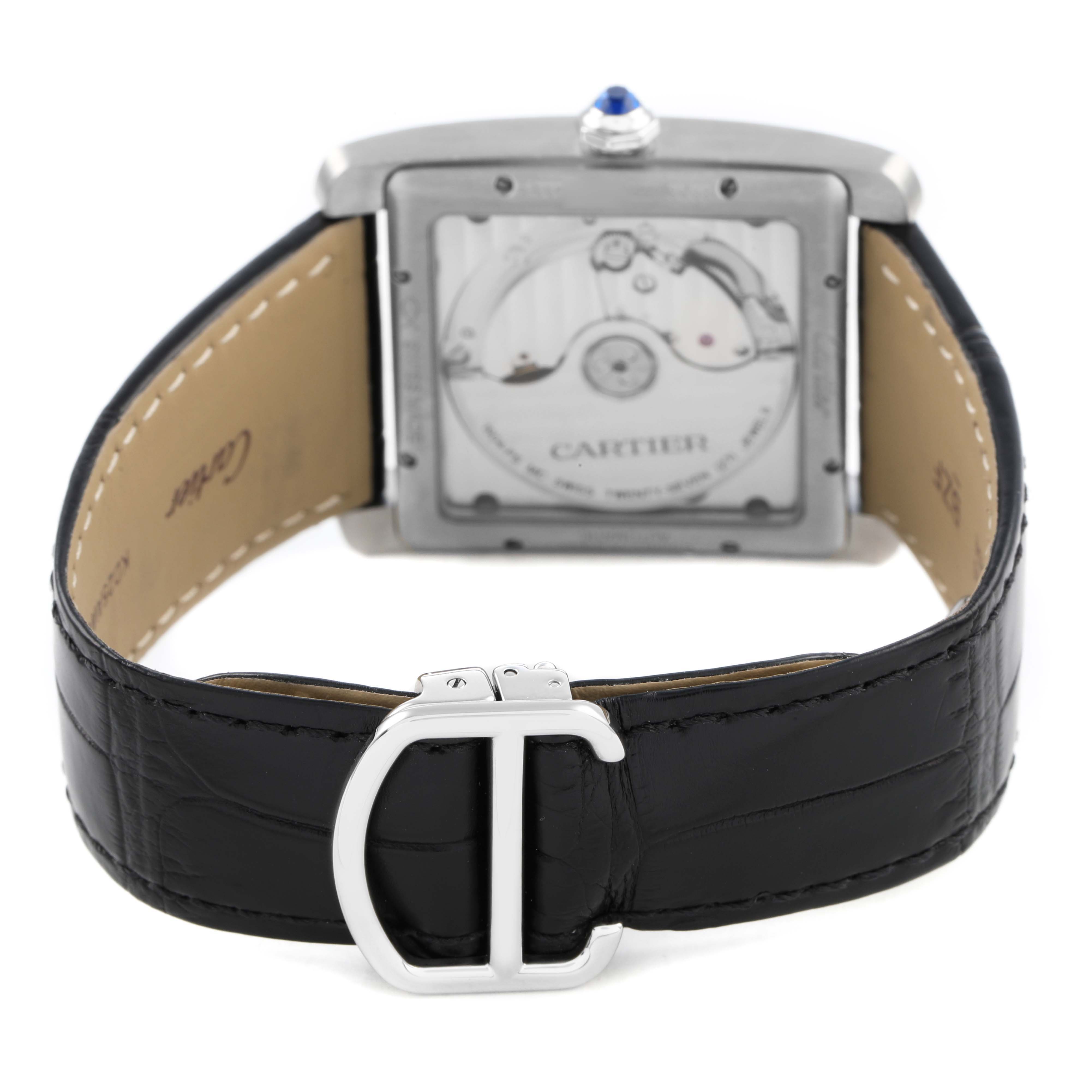 The Cartier Tank MC W5330003 Men's Stainless Steel Silver Dial watch is shown from the back, highlighting its movement and black leather strap with a silver buckle.