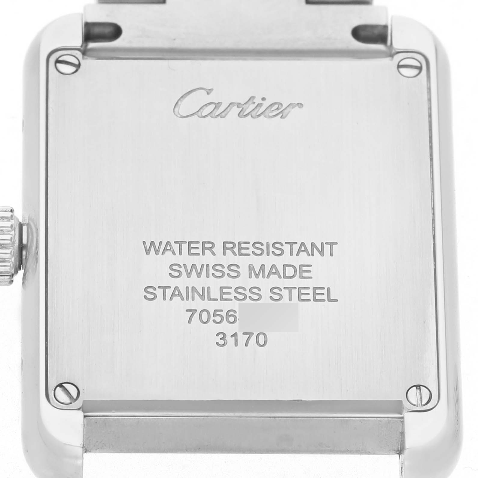 The image shows the back case of a Cartier Tank Solo W5200013 Women's Stainless Steel Silver Dial watch with engraved details.