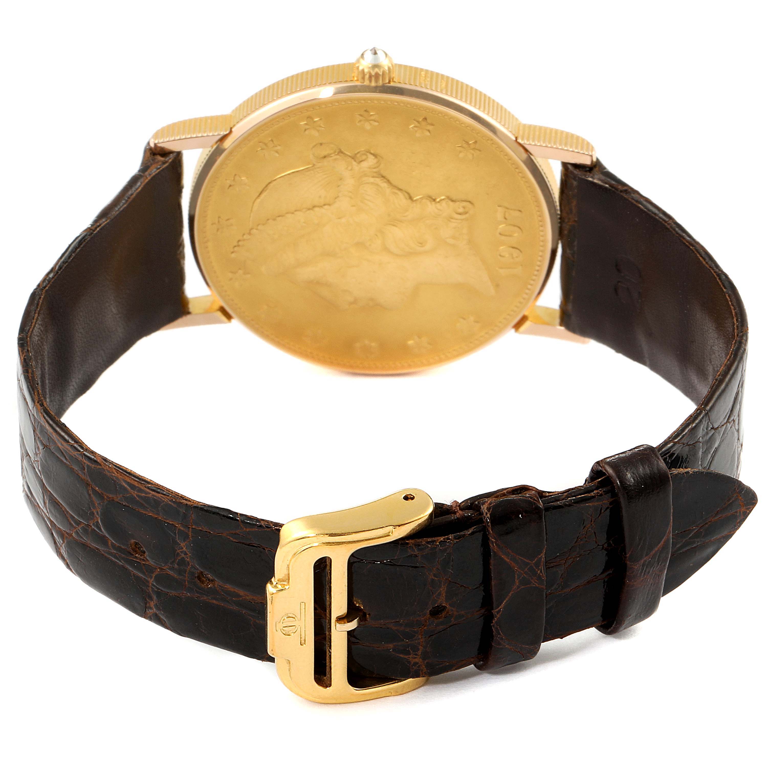 The image shows the back view of the Corum Coin Watch  Men's Yellow Gold Black Dial  Men's Yellow Gold Black Dial model, featuring a gold case and a dark leather strap with a gold buckle.