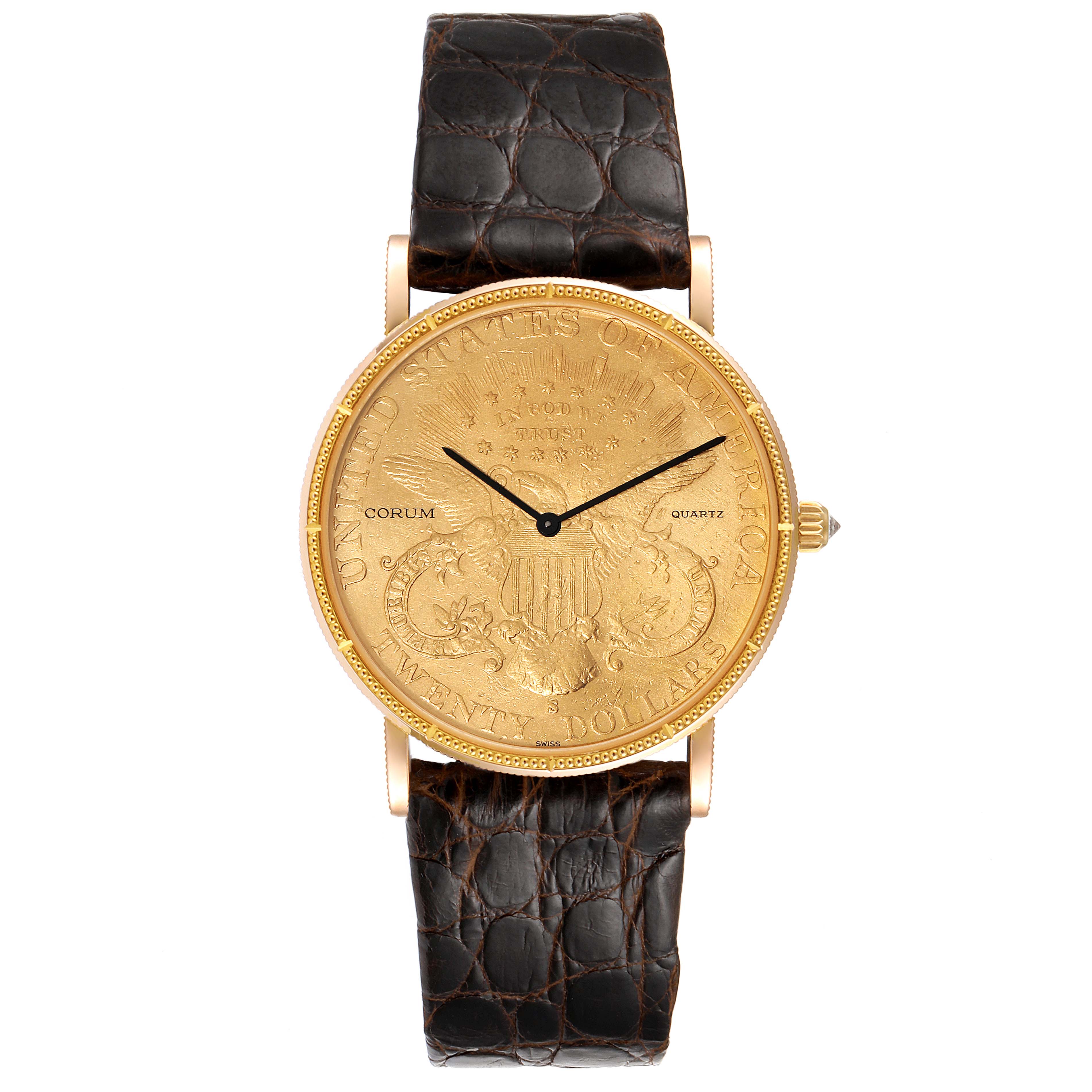 The Coin Watch model by Corum is shown from a straight-on angle, displaying the face, bezel, crown, and strap.